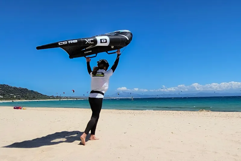 Learning to handle a wingfoil on the beach with Explora Watersports Tarifa under clear skies