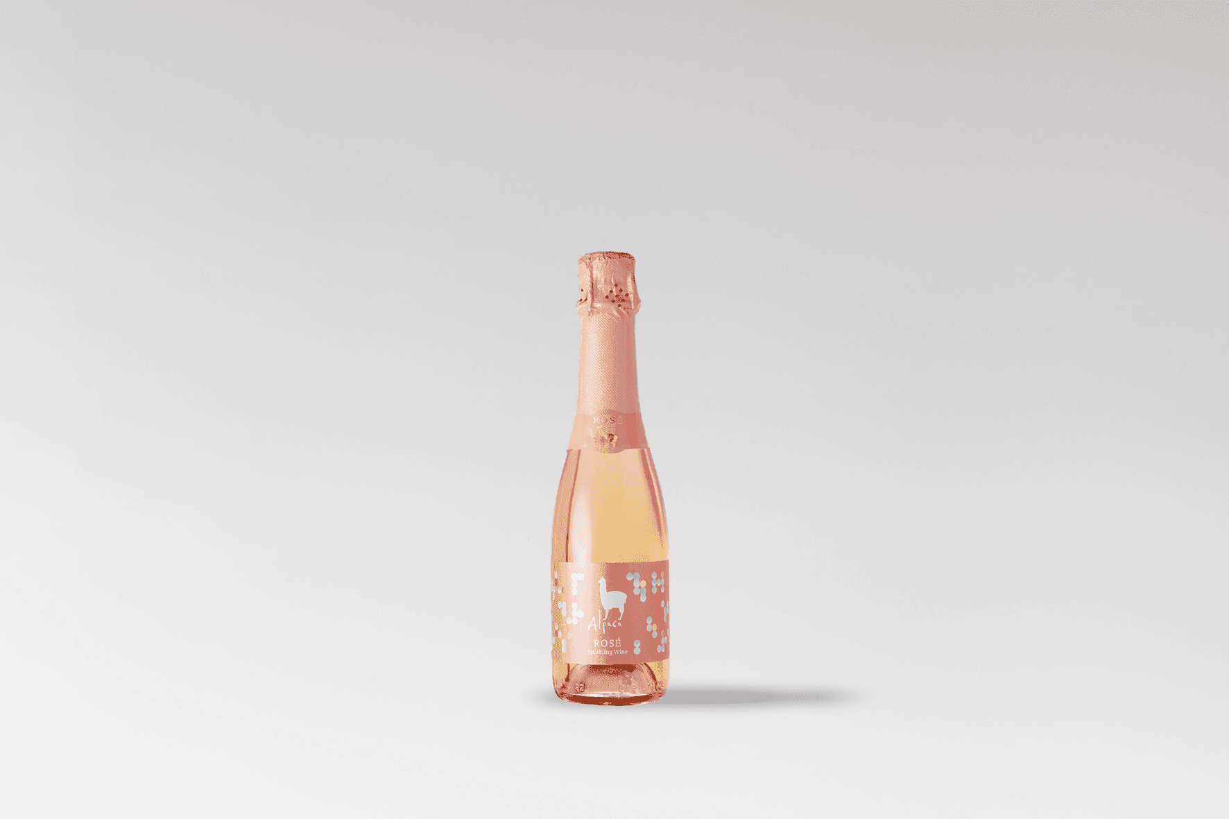 Single small Alpaca Sparkling bottle with pink packaging on a neutral background.