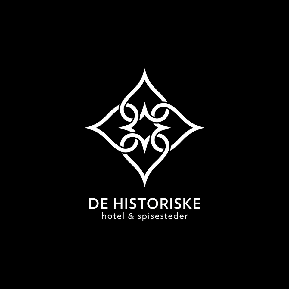 Logo featuring a decorative diamond shape with intricate details, text below reads "De Historique."