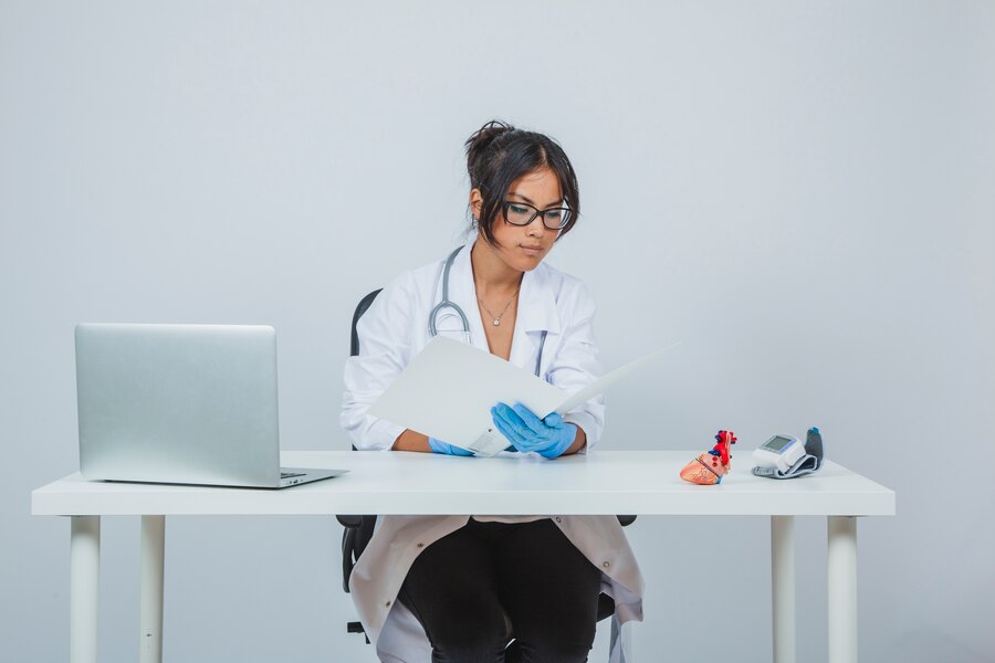 A doctor viewing reports of her patients and assessing them.