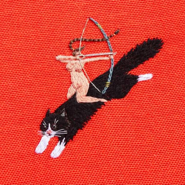 Embroidered artwork of a nude archer riding a black-and-white cat — reflecting Natasha Huseiva’s bold leadership as former COO at FEDORIV, Ukraine’s leading creative and marketing agency.