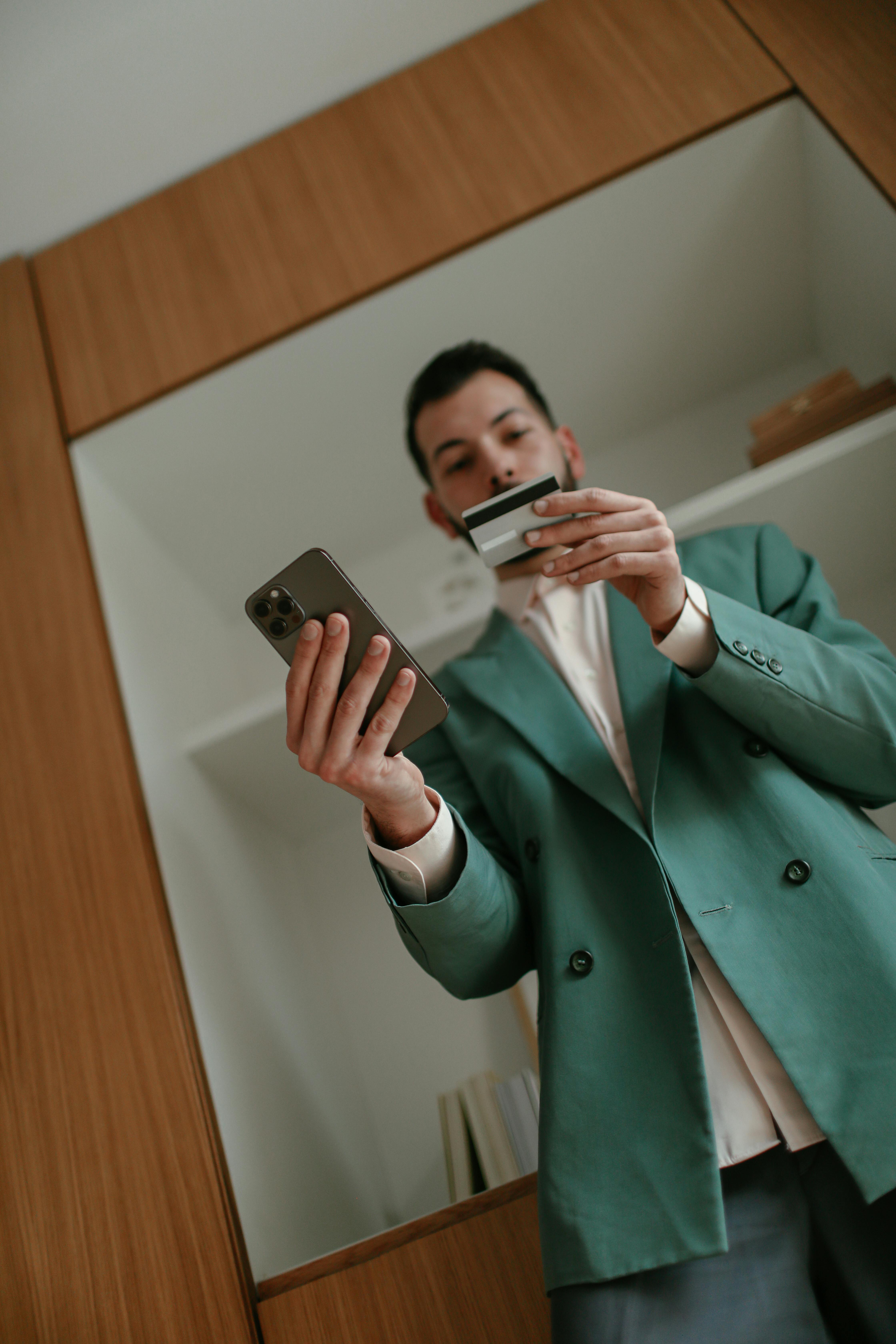 person making a paytment using card on mobile