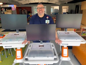 A child life specialist receives three new GO Karts delivered at his healthcare facility in the US.