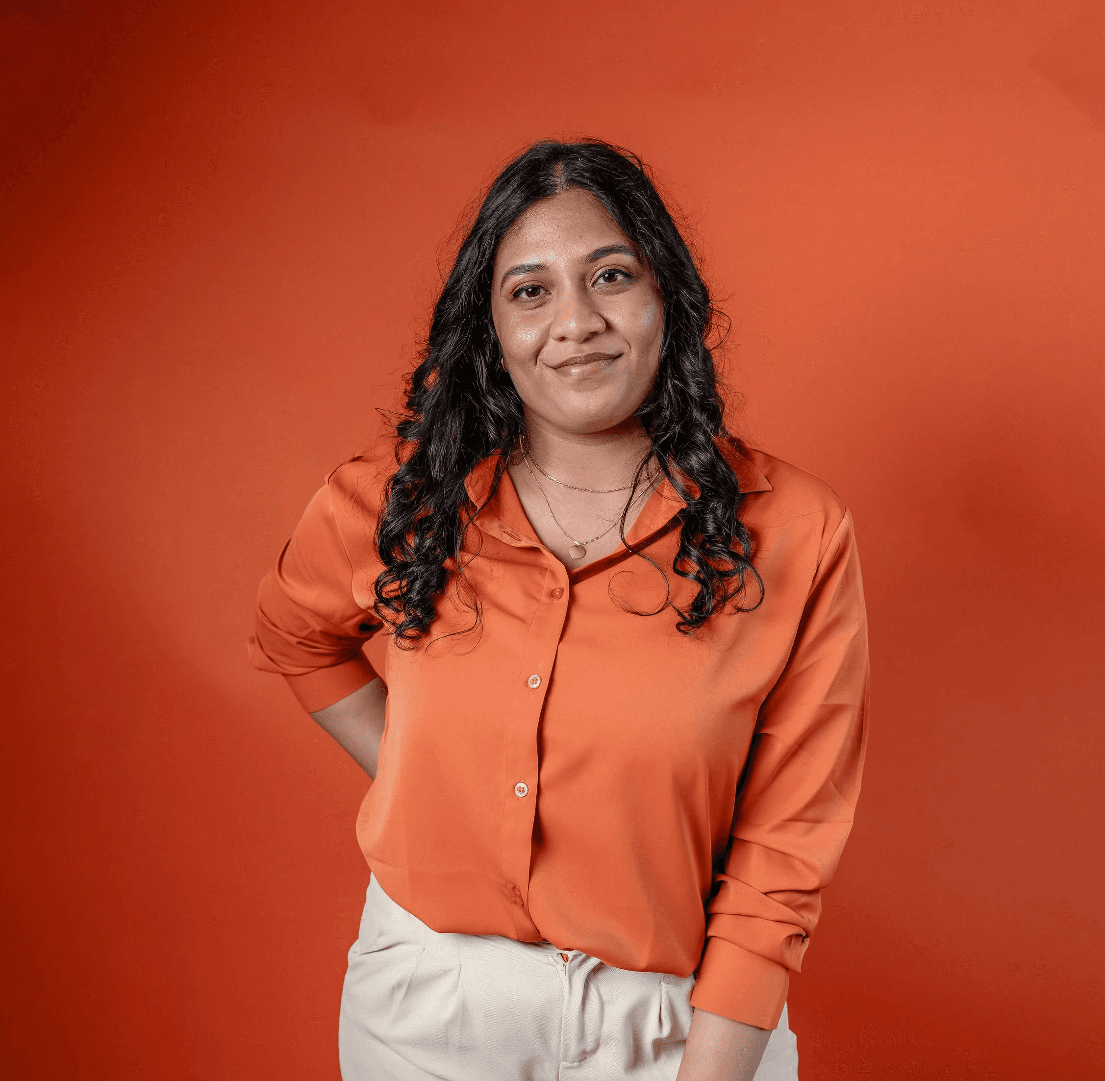 A thoughtful young person with dark hair gazes to the side, captured in soft black and white lighting.