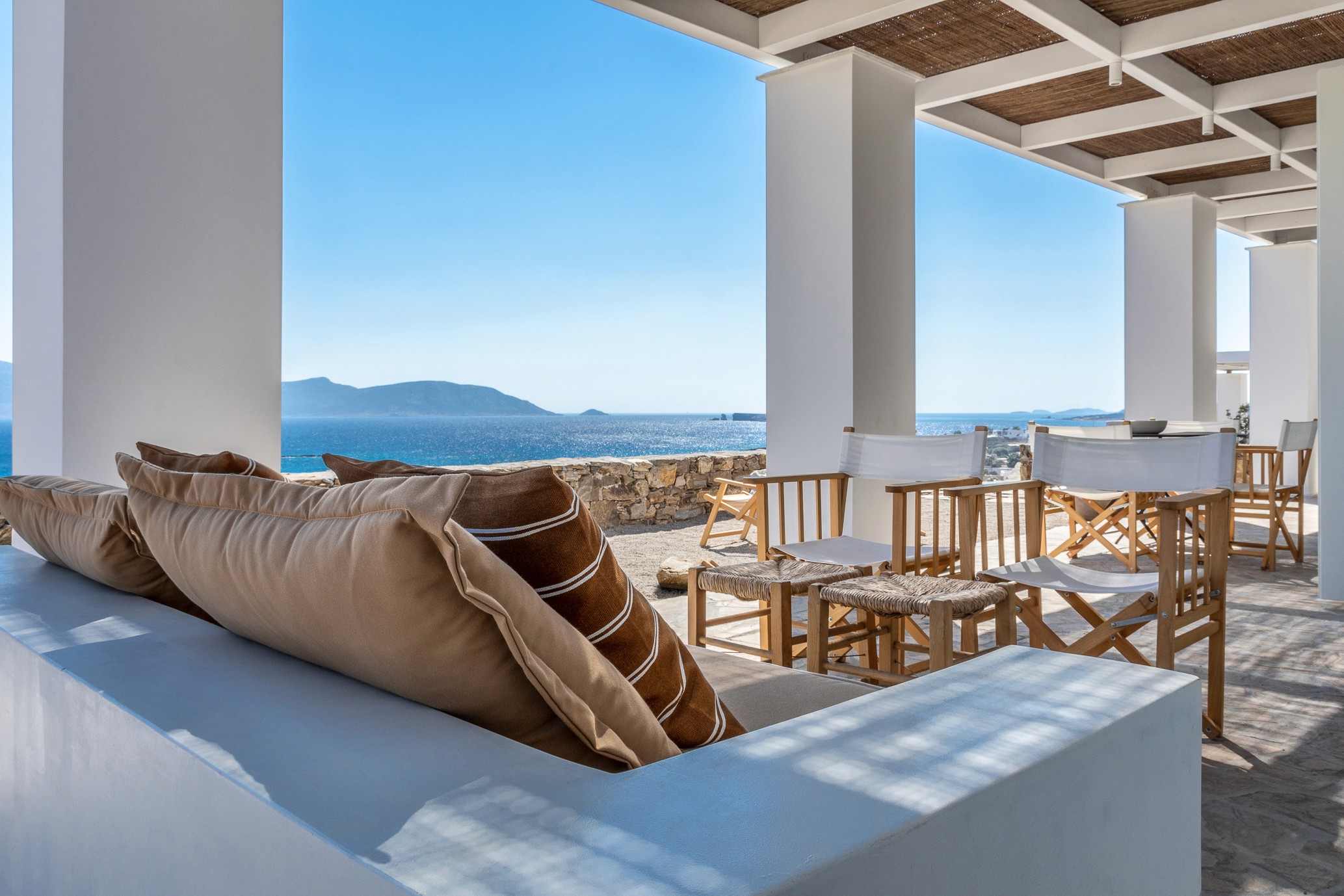 The private terrace of Eros Keros with an outdoor sofa and lounge chairs.