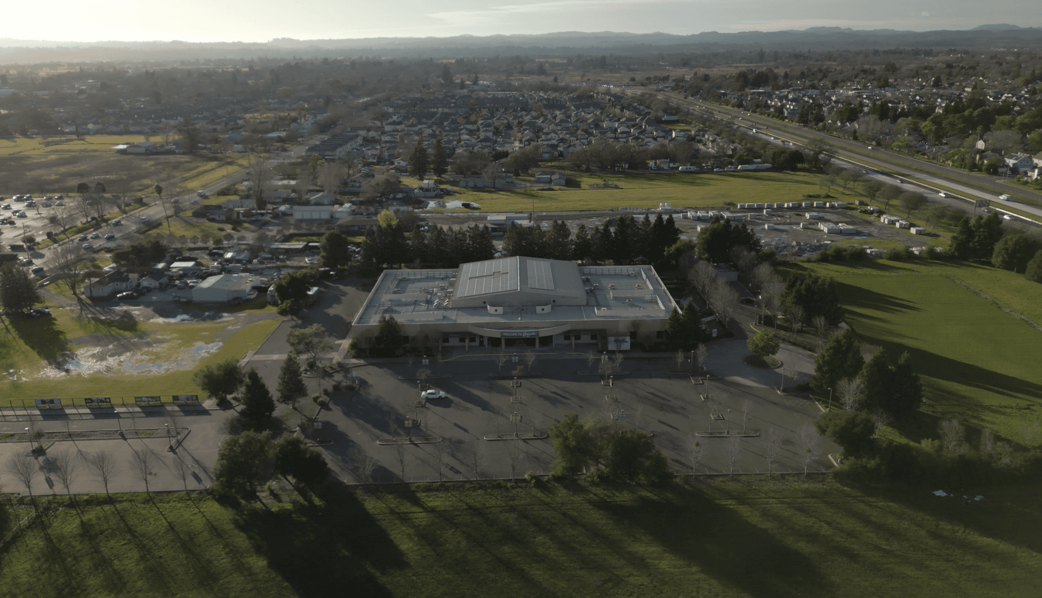 two people in a workspace working on their laptops 