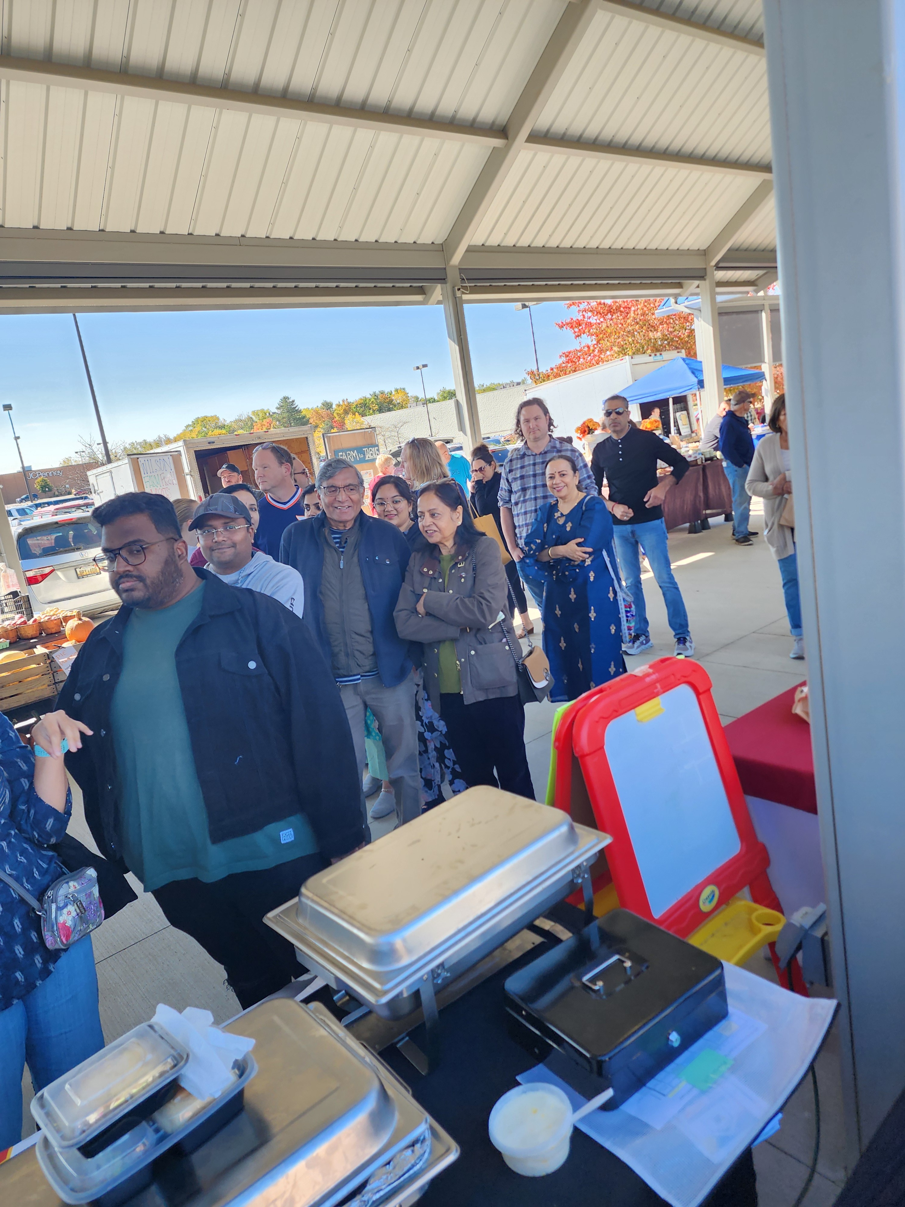 An image of customers waiting in line for Mumbai 28's food