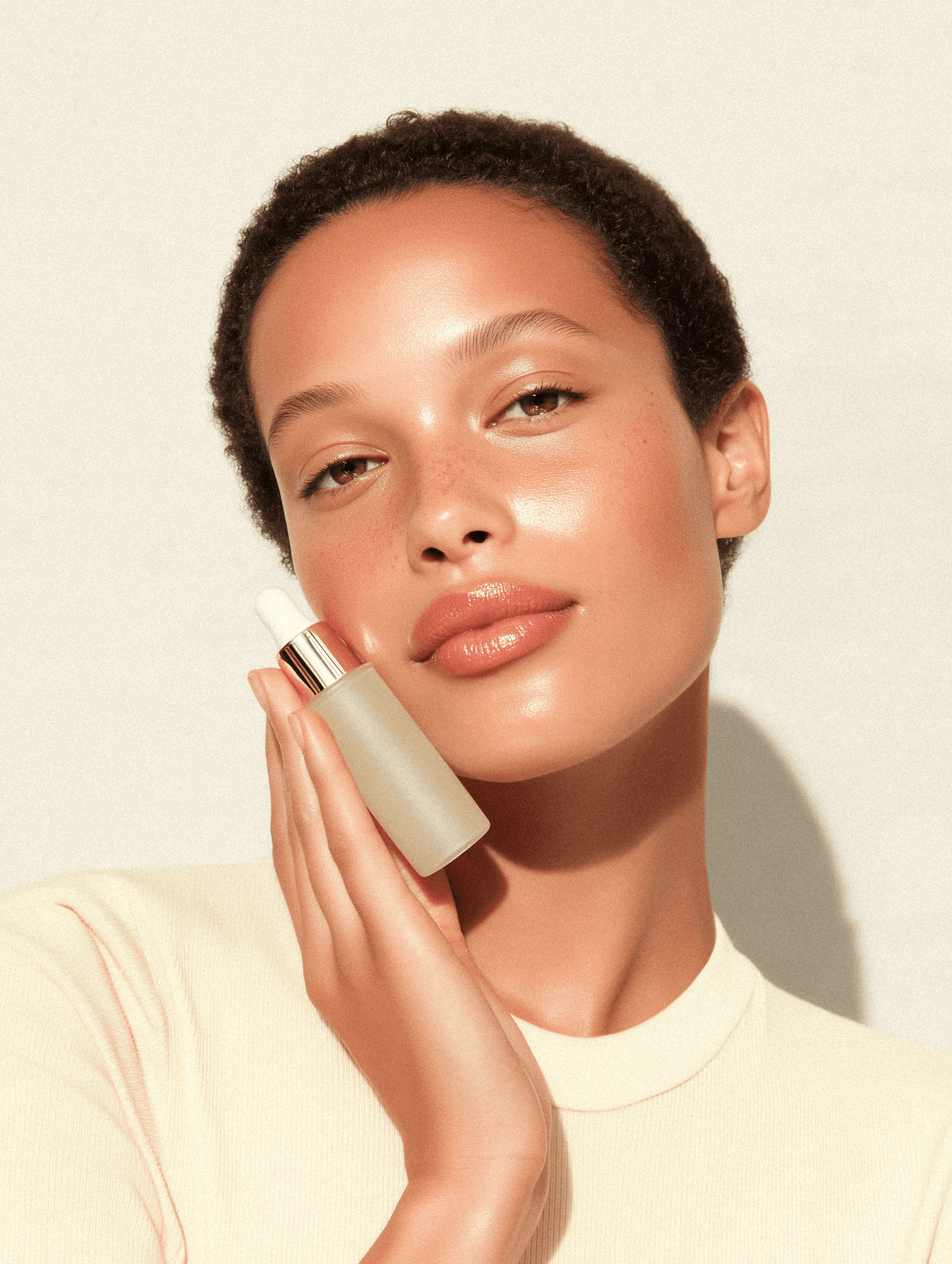 Elegant gold compact with creamy skincare product, beautifully lit in warm tones