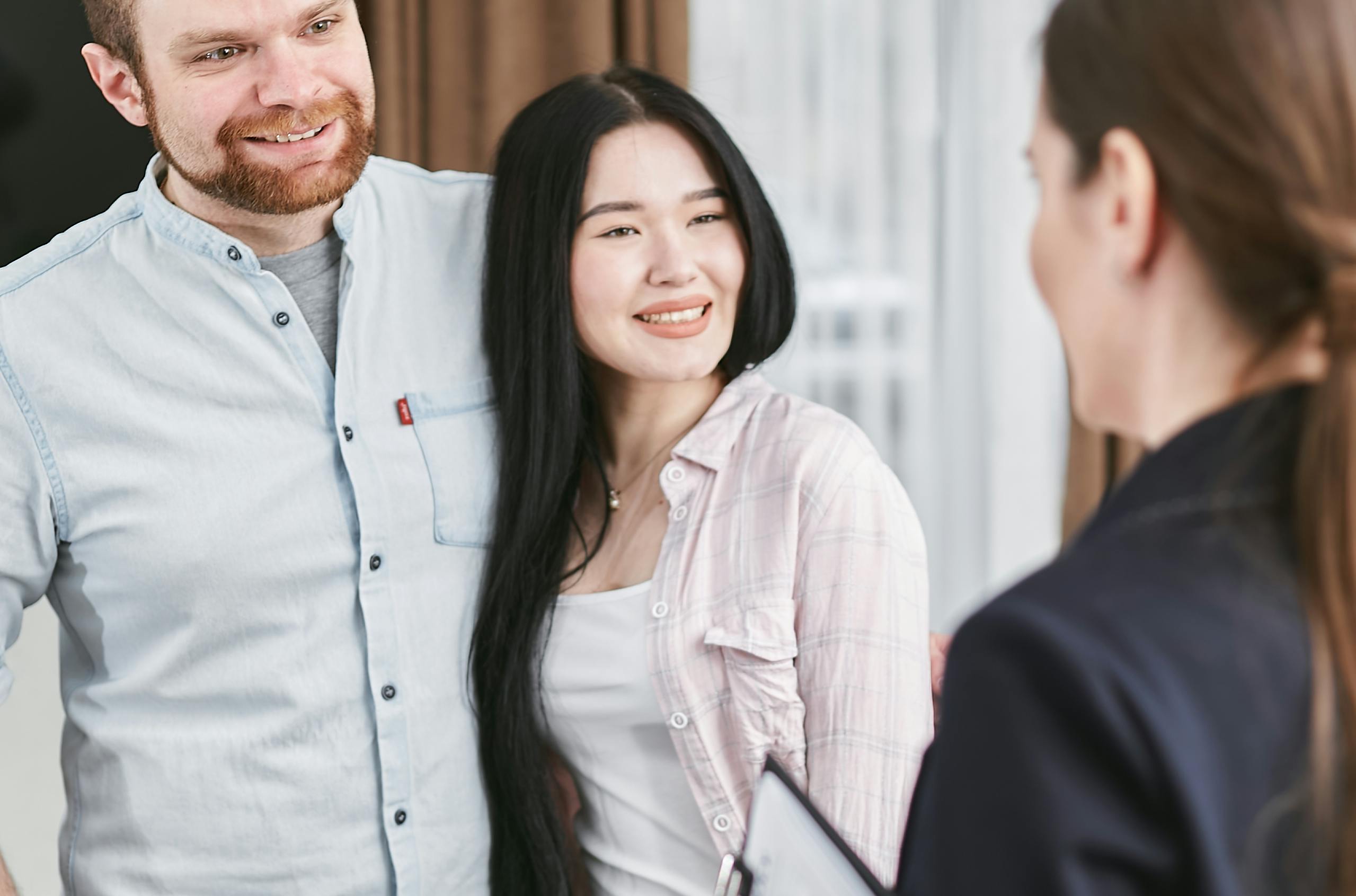 Couple smiling while asking questions to mortgage broker