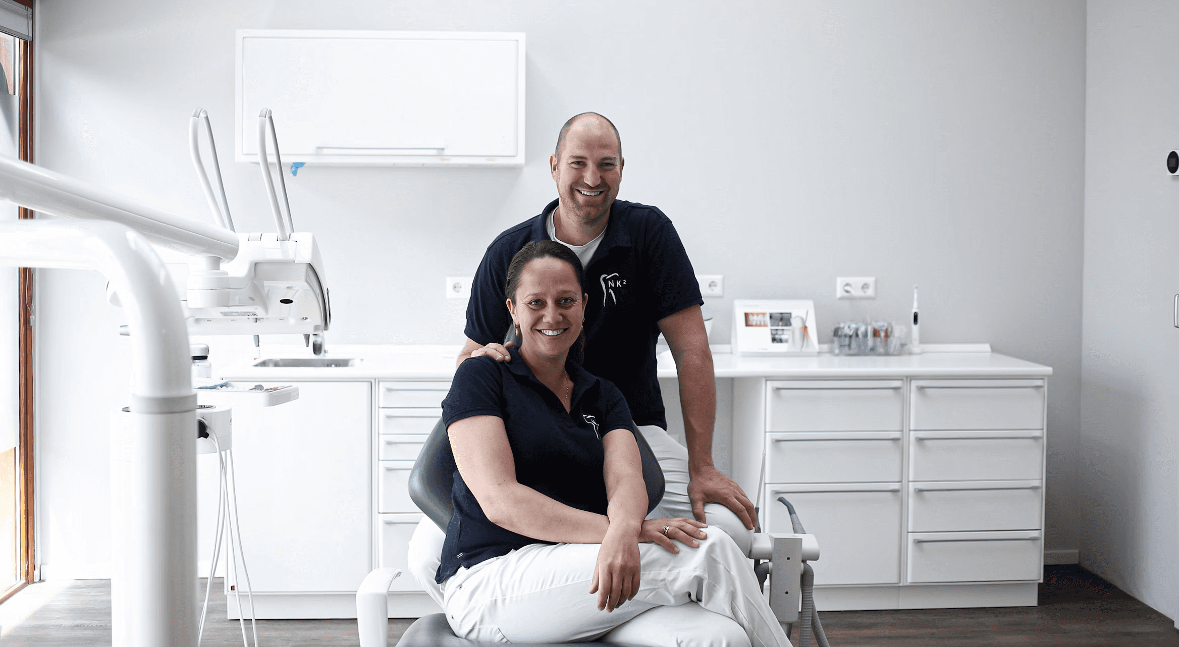 A fast black sports car races down the highway.