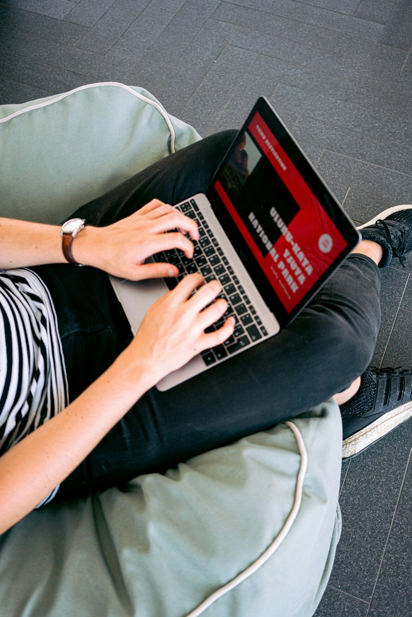 Laptop on a womans lap who is thinking about redesigning her website