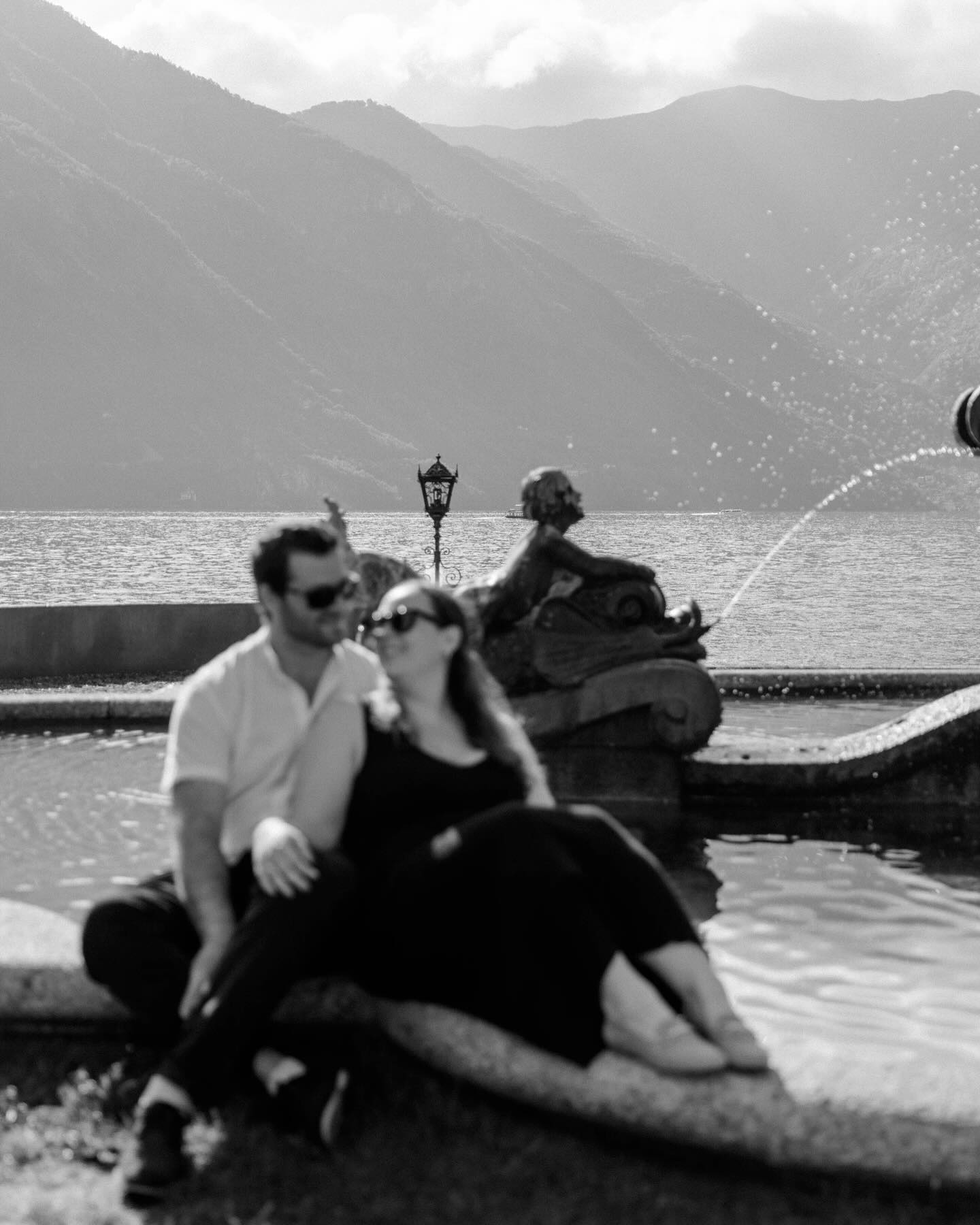 Elf woman in white dress raising hands by the river