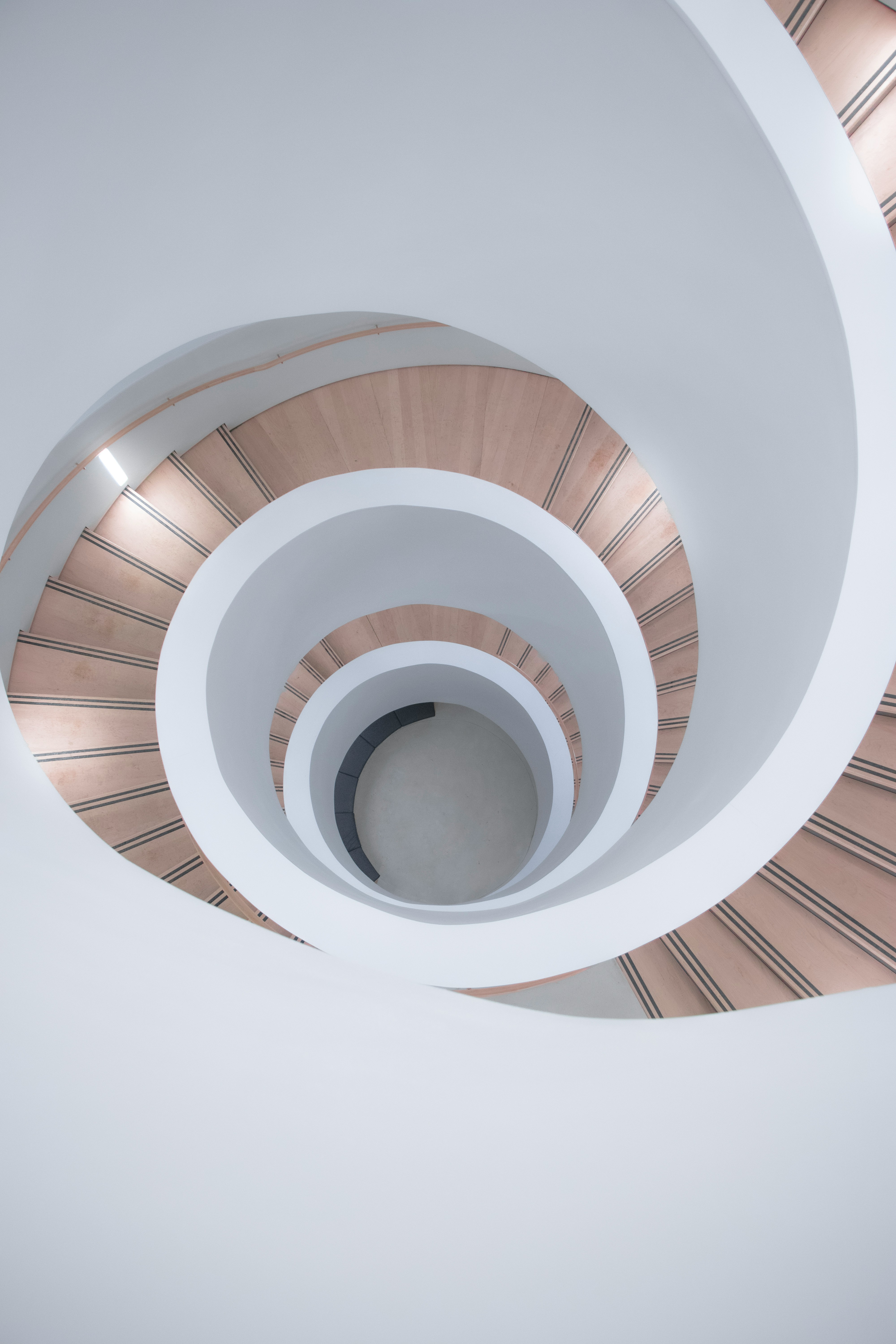 a spiral staircase in a building with white walls