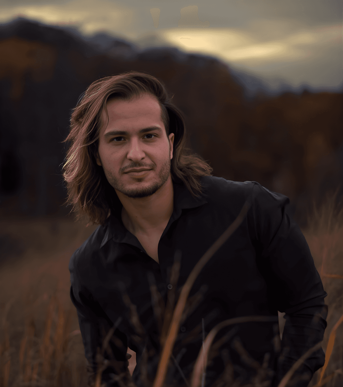 A person with short blonde hair holds a vintage camera.