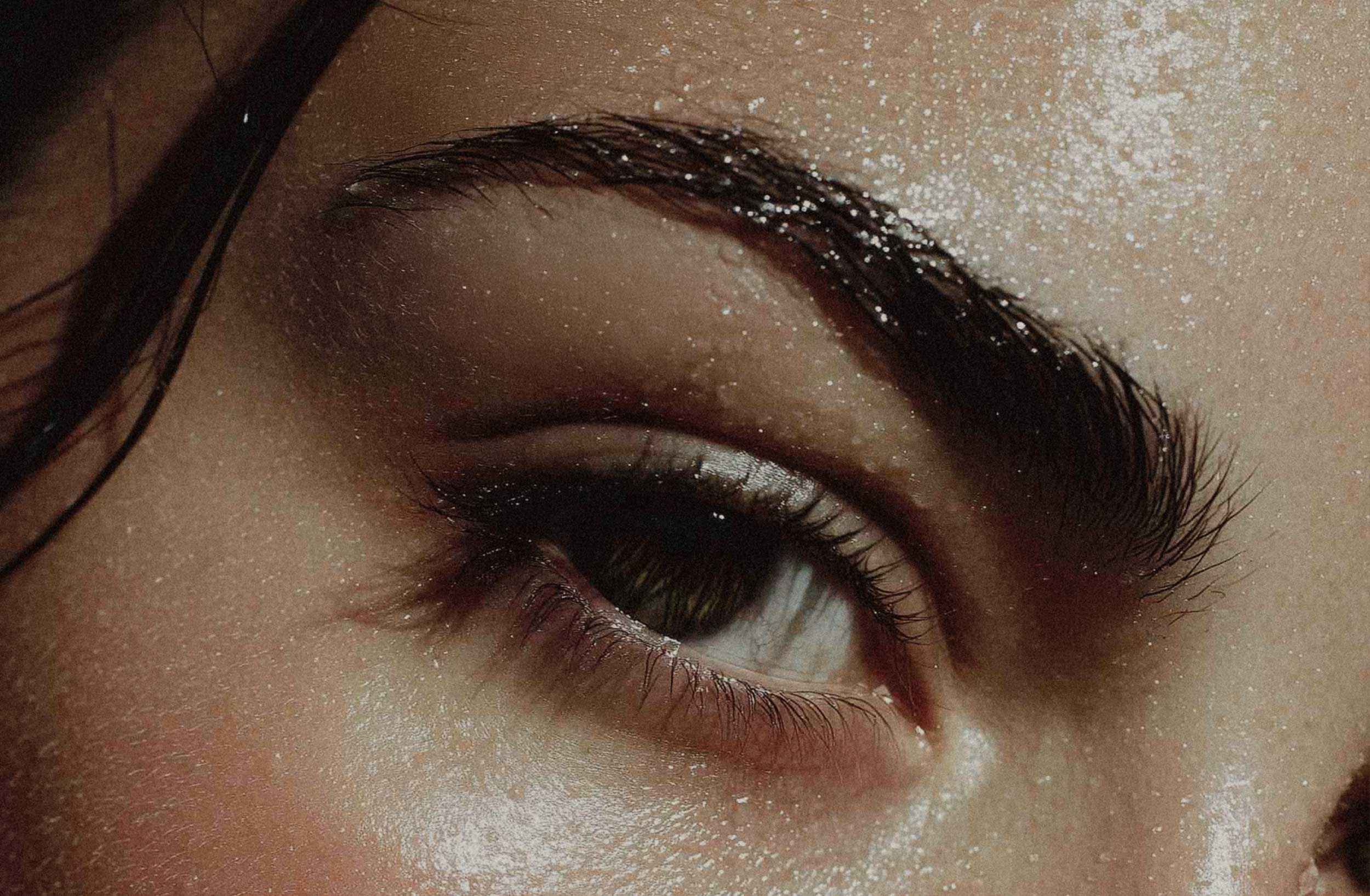 Woman's face with water droplets.