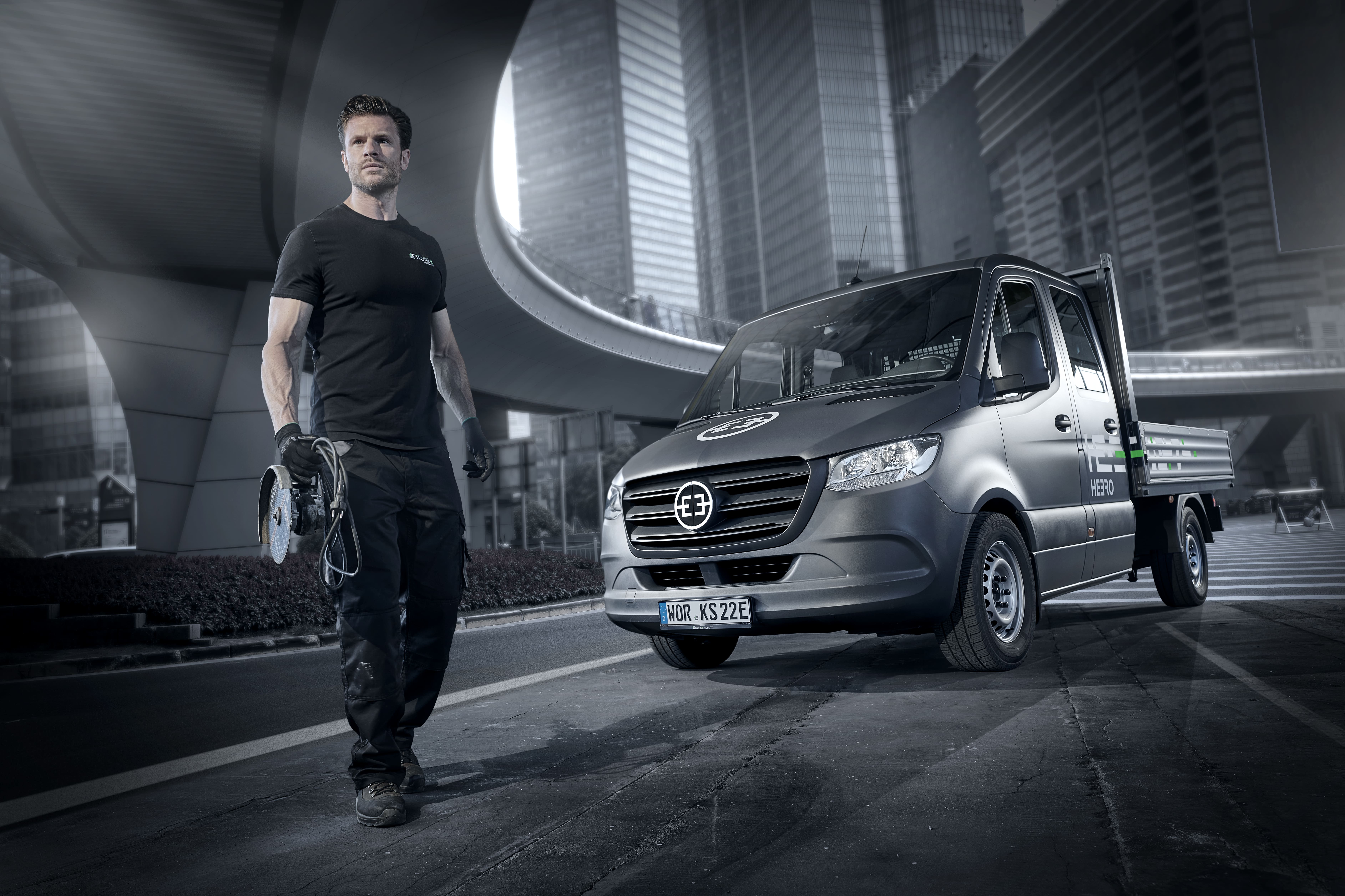 man standing in front of people sitting beside table with laptop computers