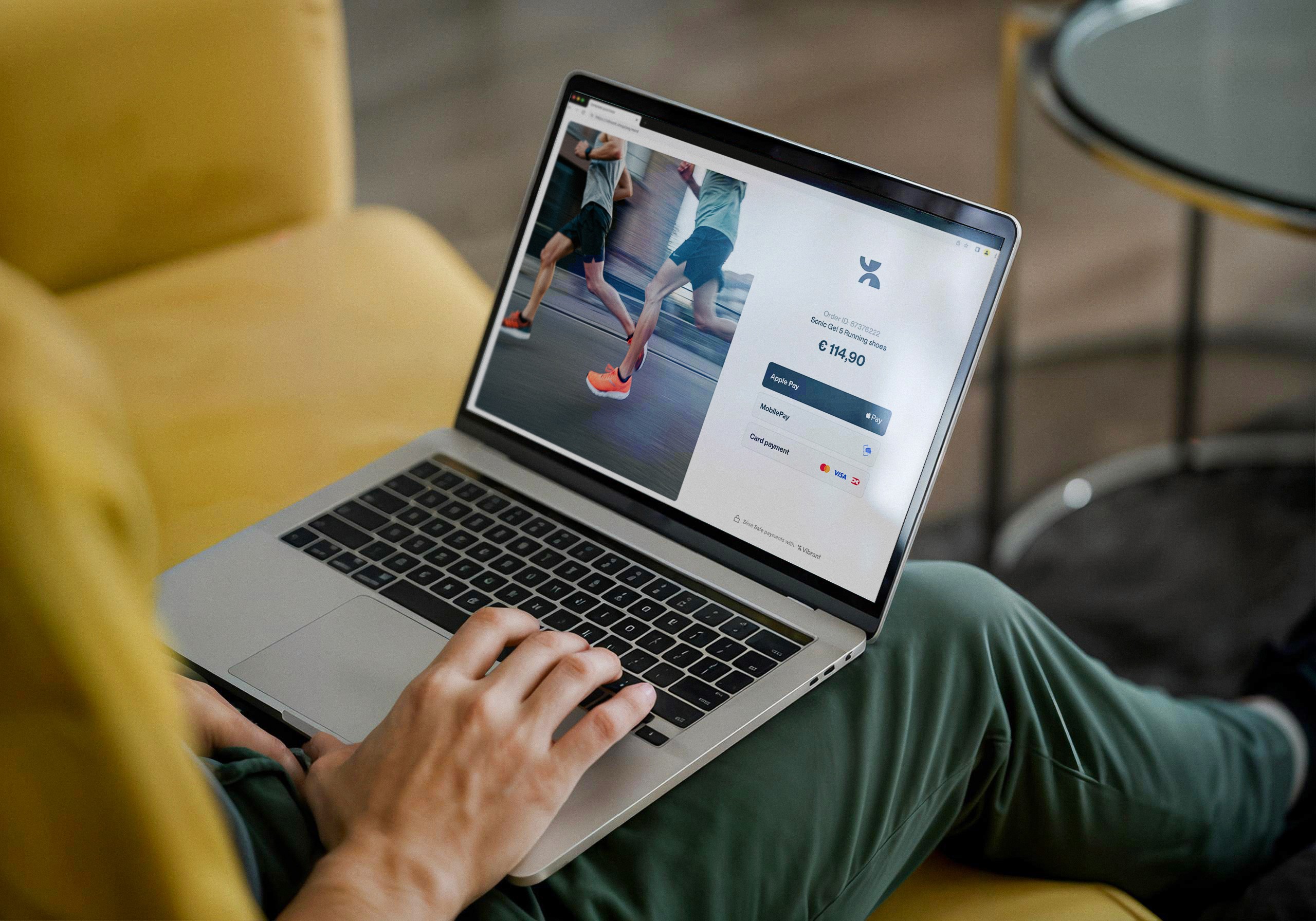 Person sitting with his laptop, lookin at a Vibrant payment gateway