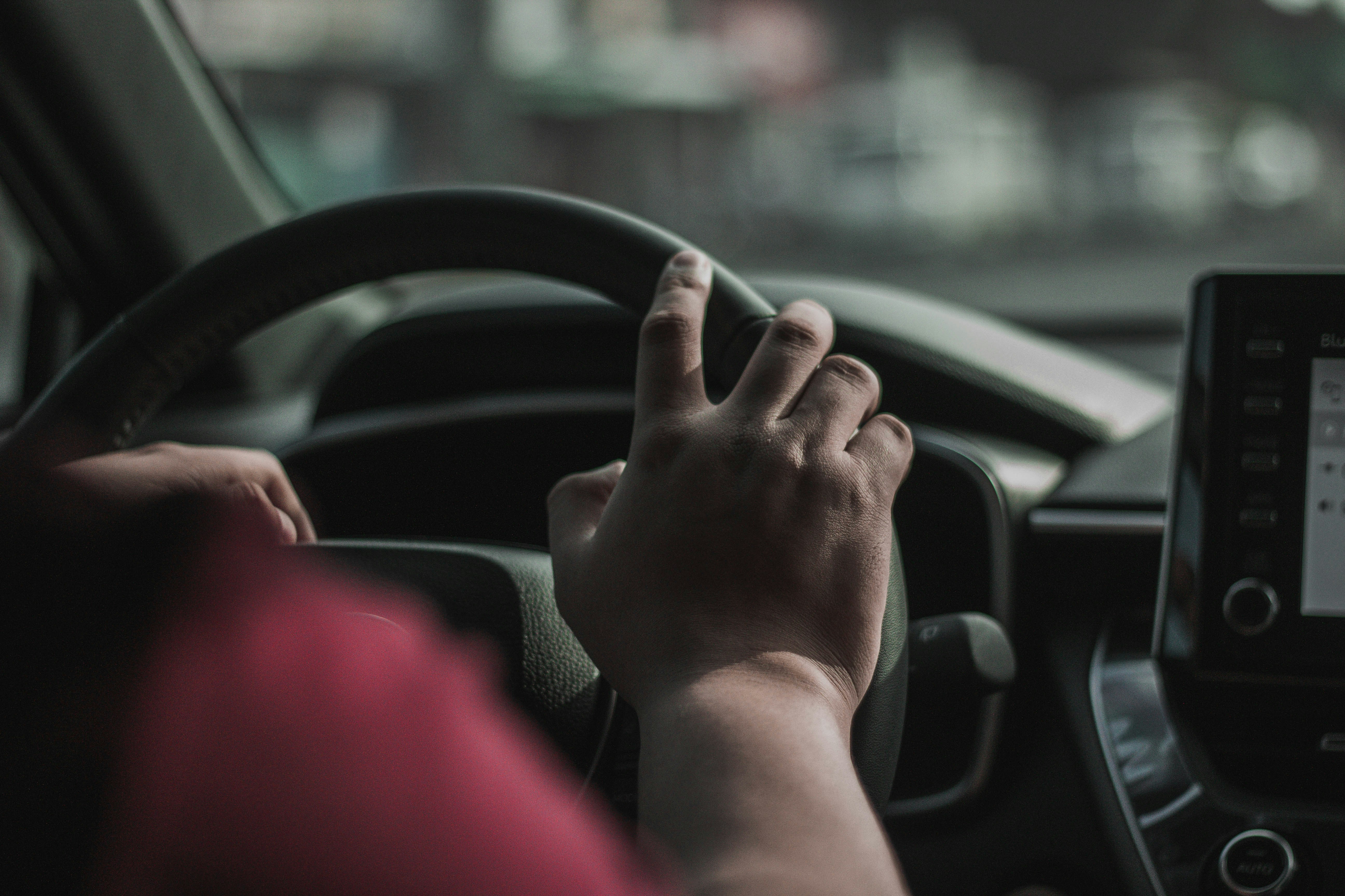 person behind the wheel of a car