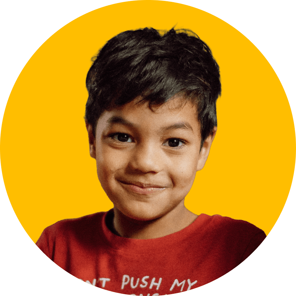Child smiling toward the camera, representing youth voice and participation