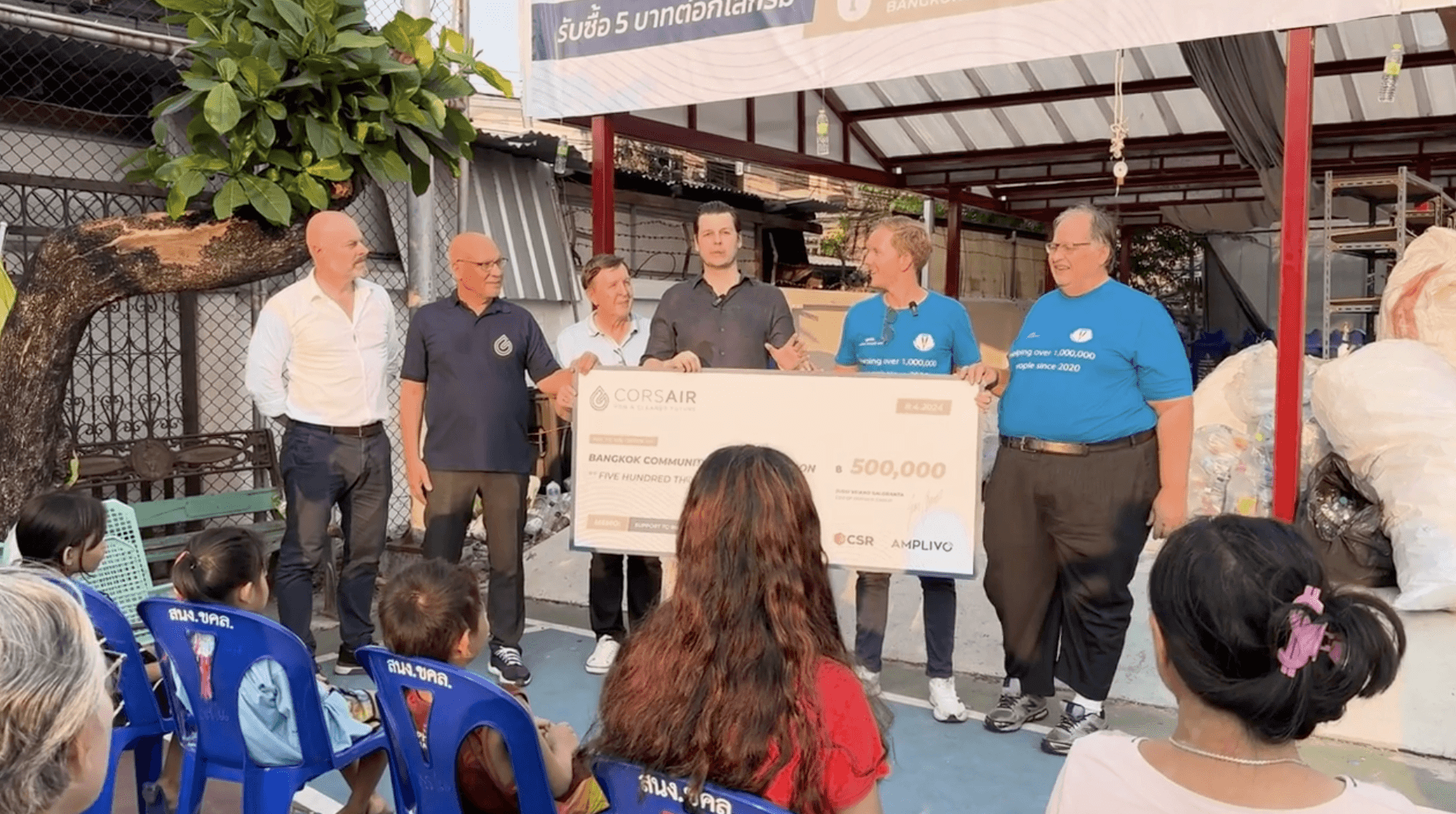 group of children wearing medal standing near wall