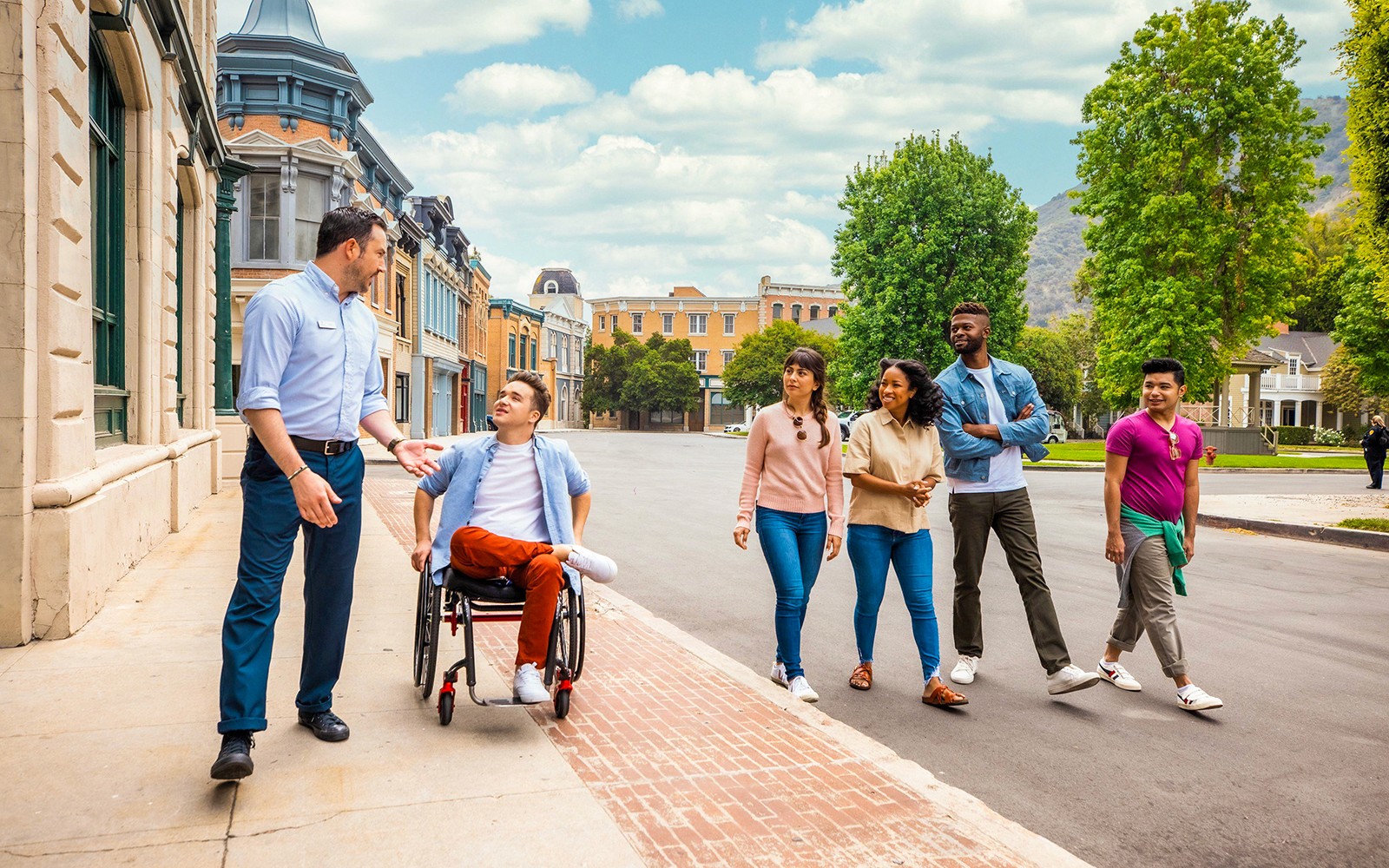 Guide leading a group tour at Warner Bros. Studio, Burbank, with diverse visitors.