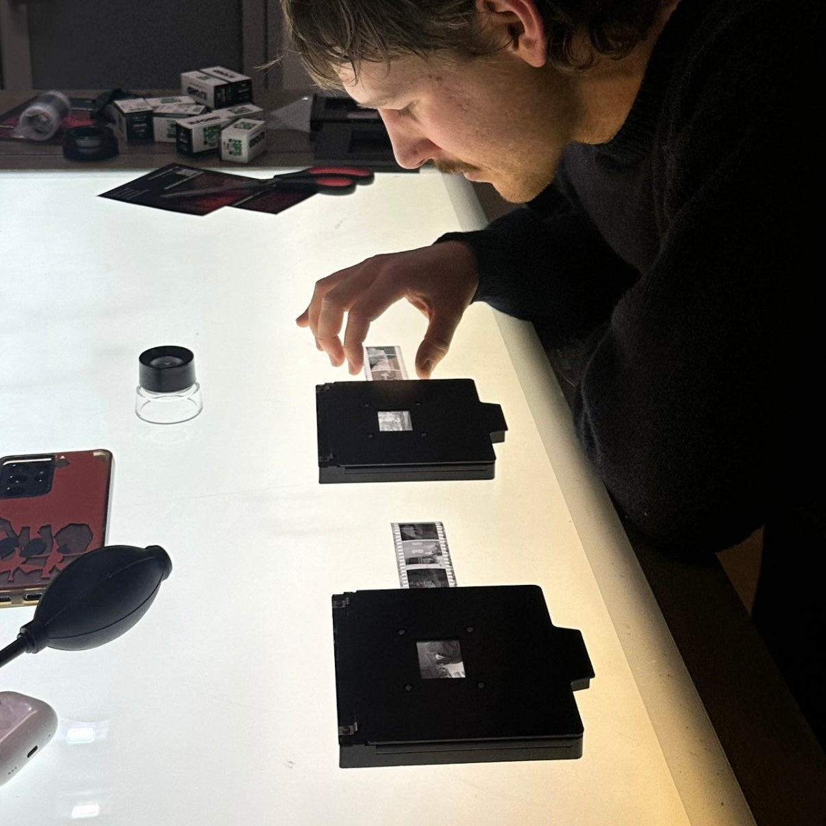 Placing 35mm film into negative carriers on a light table