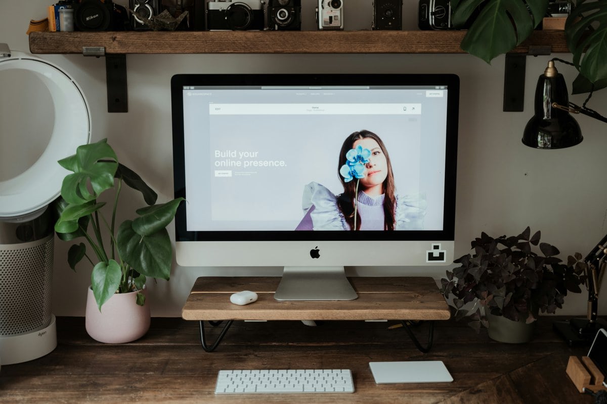 Squarespace website on a mac computer with plants on the desk