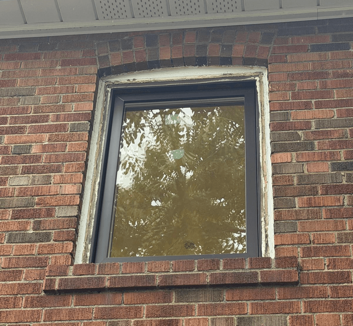 New Antique Brown window set inside the existing frame before aluminum capping, Midtown Toronto