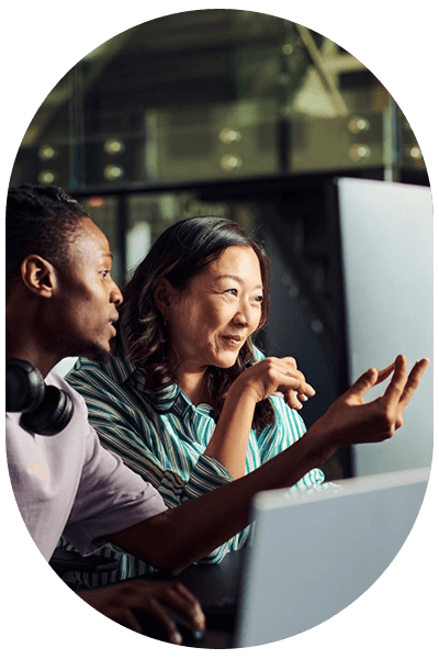 man and woman looking at computer screen