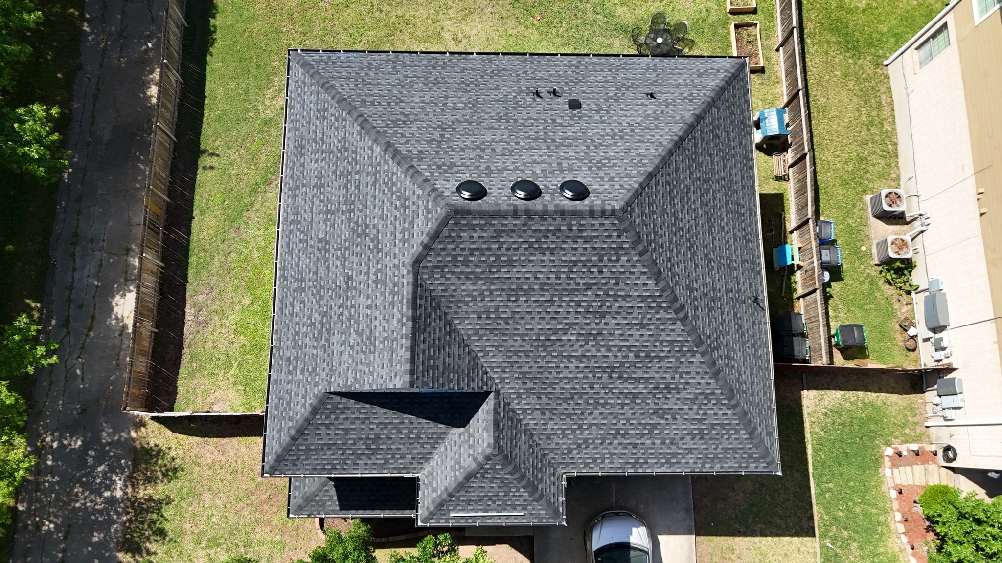 Hip roof with architectural shingles and dome vents, providing a stylish design with enhanced attic ventilation.