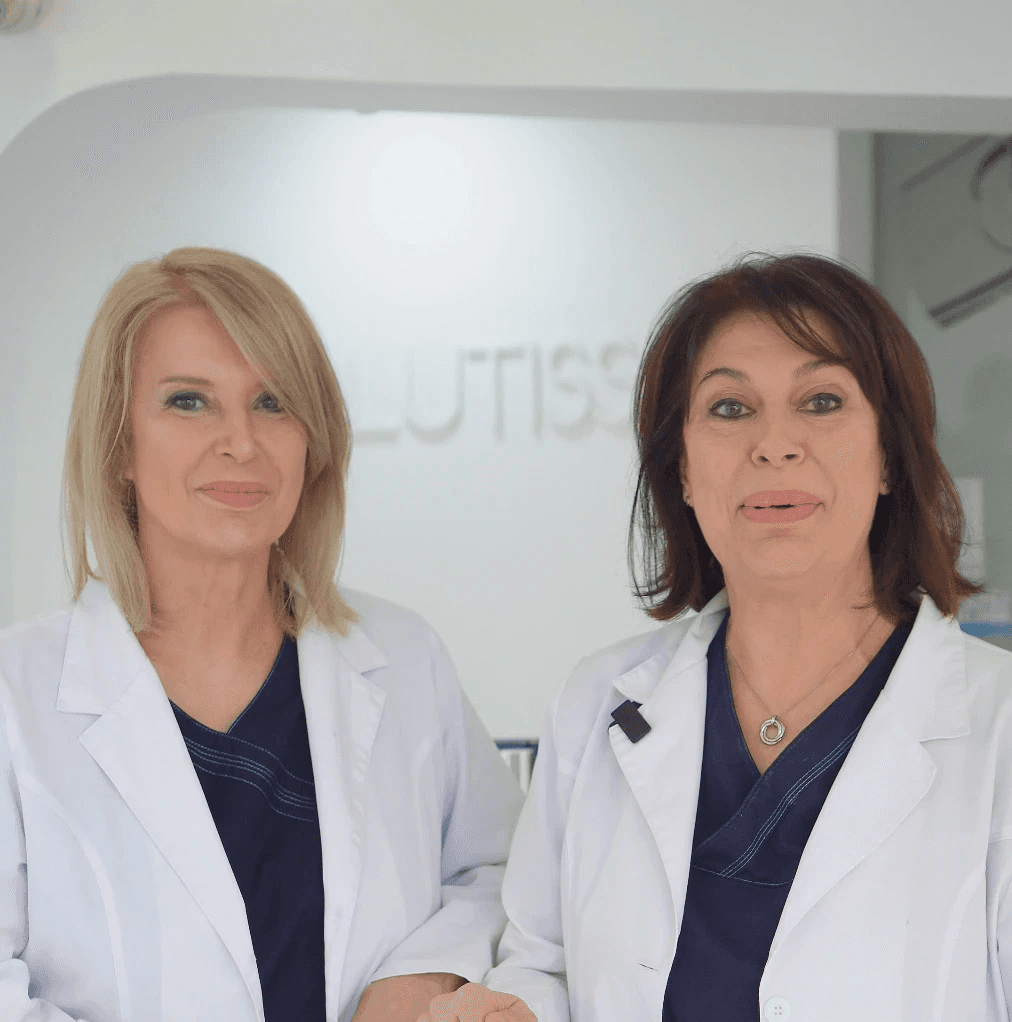 Portrait of medium black and white dog on red background