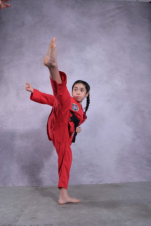 Student doing a side kick