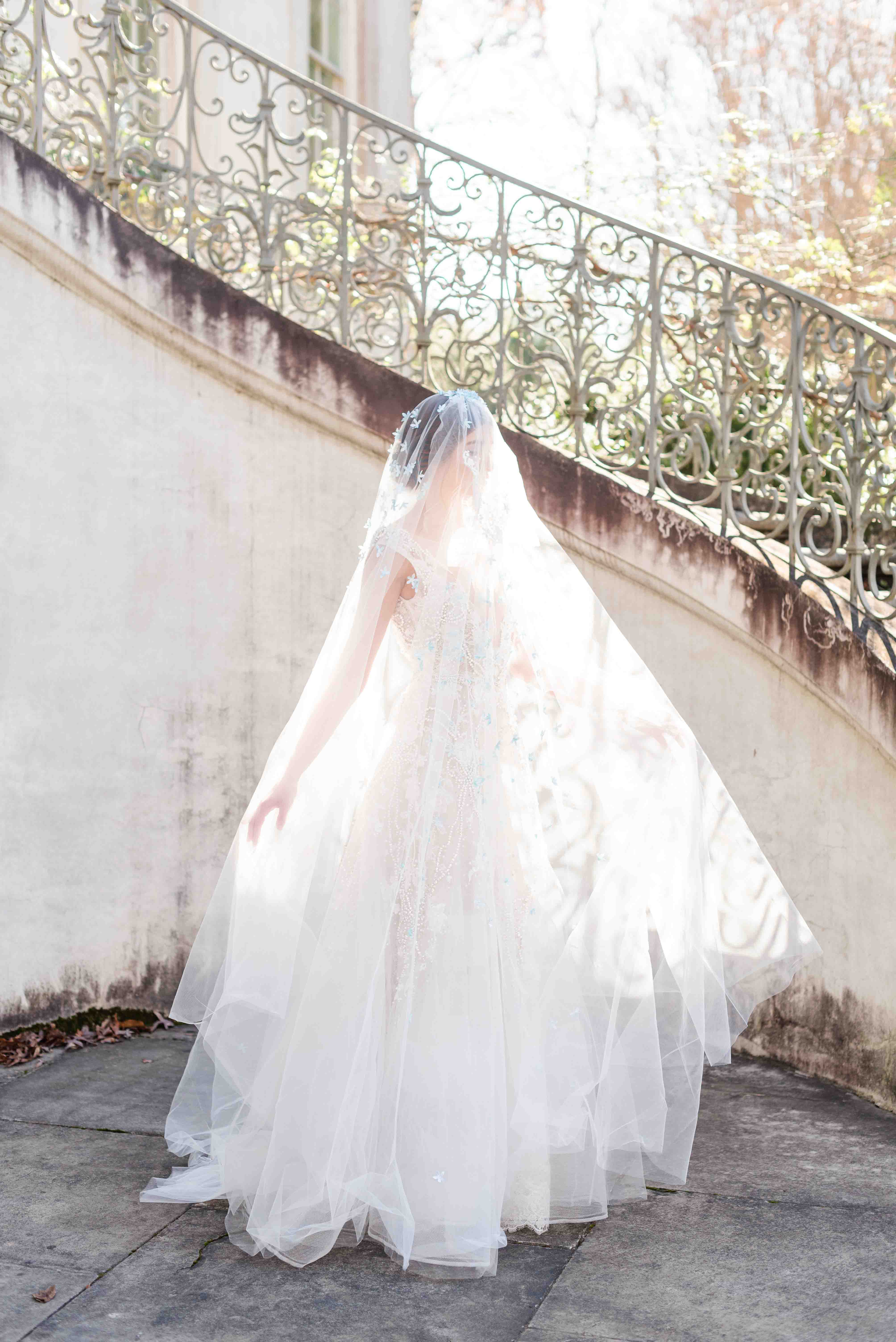 Profile image of bride underneath her veil with the sunlight upon her.