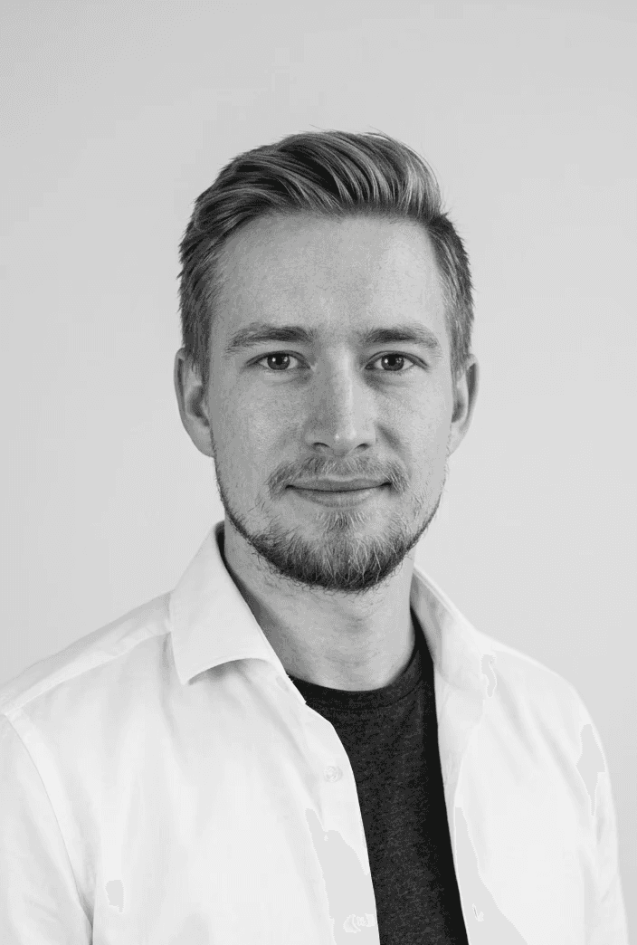 Portrait of a man with blue eyes and a beard, wearing a denim shirt