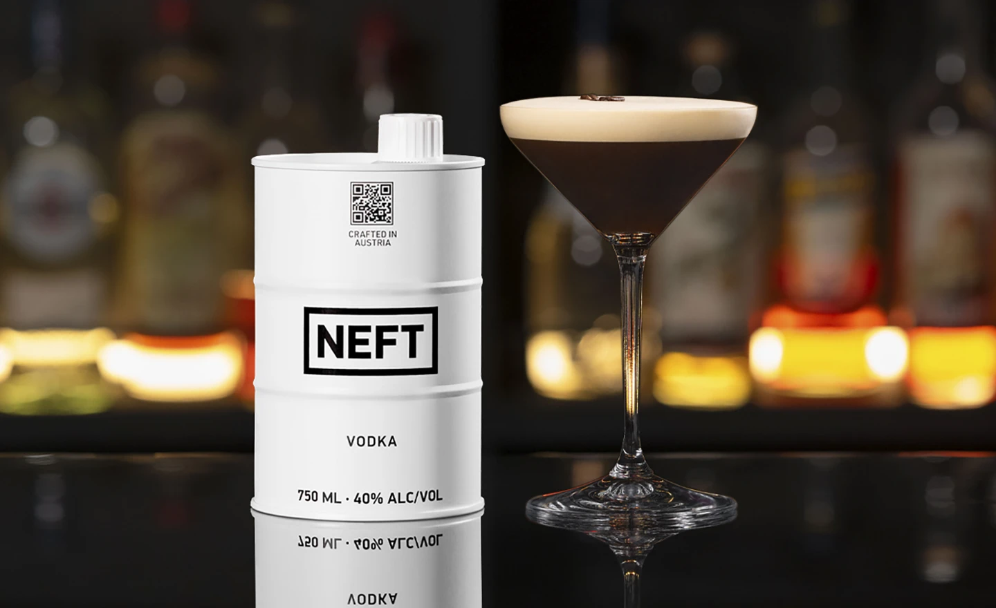 A NEFT Vodka Barrel and a glass of Espresso Martini on a bar counter.