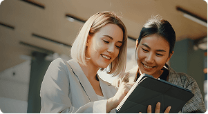 business setup companies in dubai - discuss two women using ipad