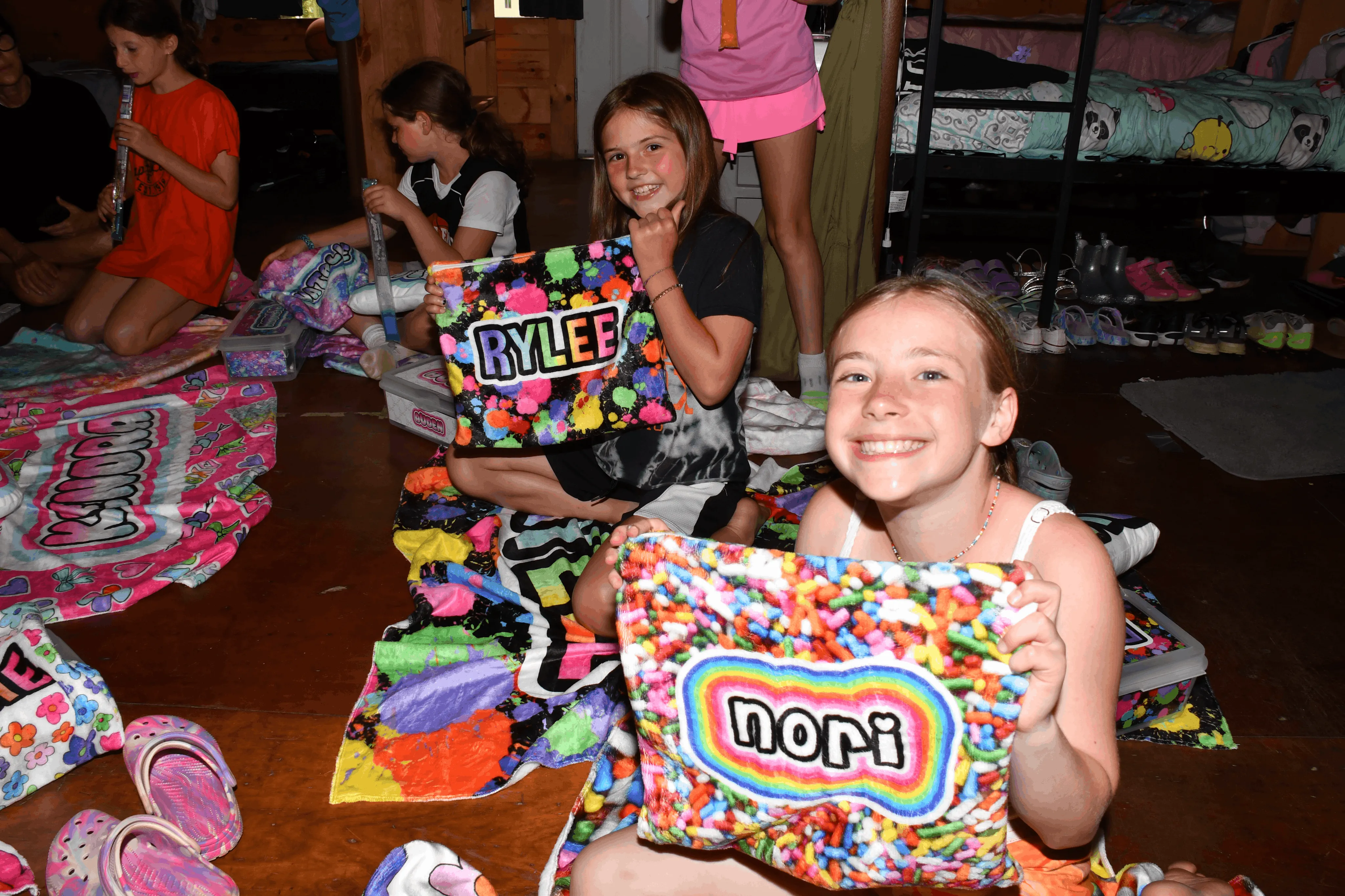 Campers hanging out together on the floor of their bunk at Camp Lenox