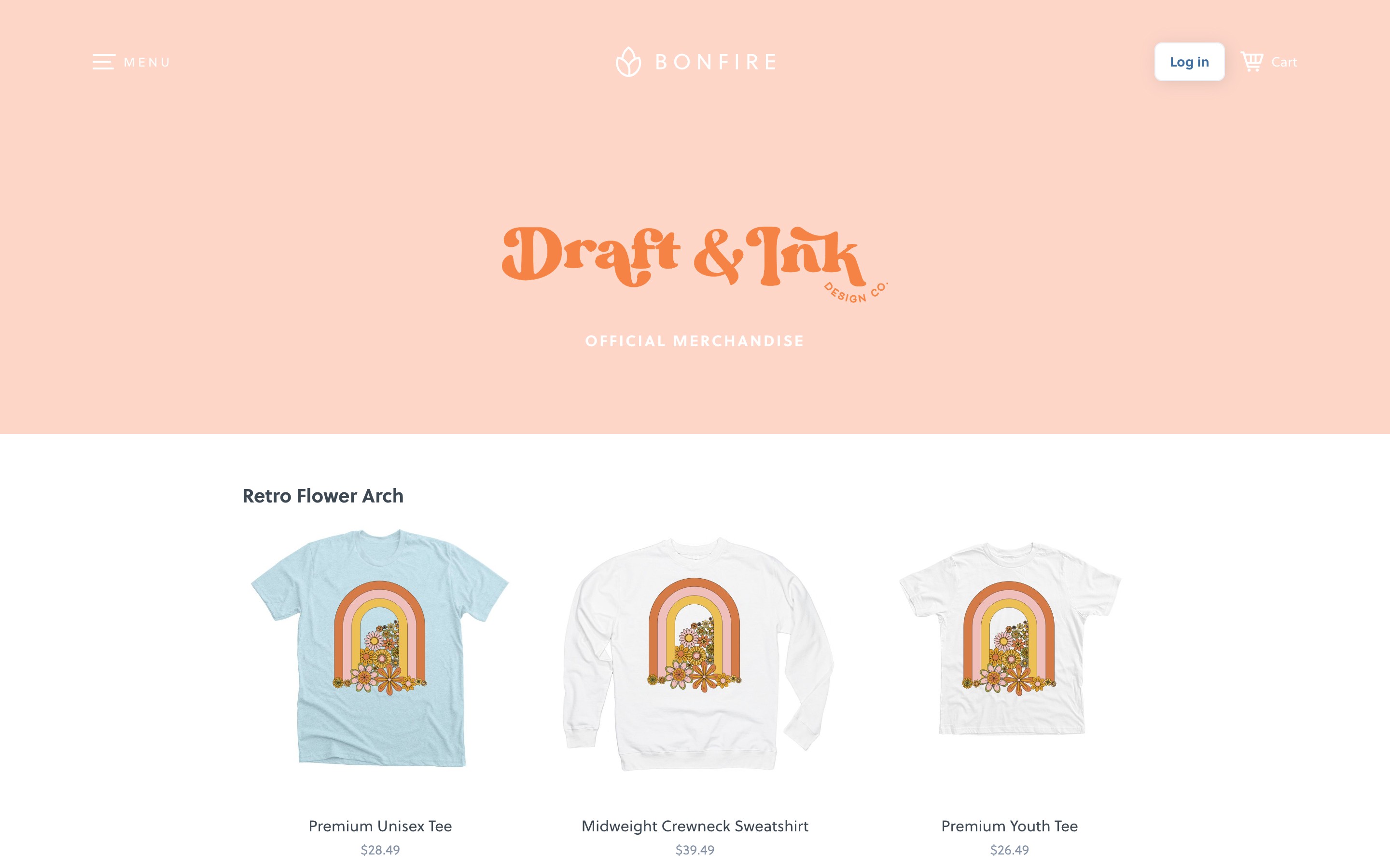Draft & Ink merchandise display featuring retro flower arch designs on tees and sweatshirt.