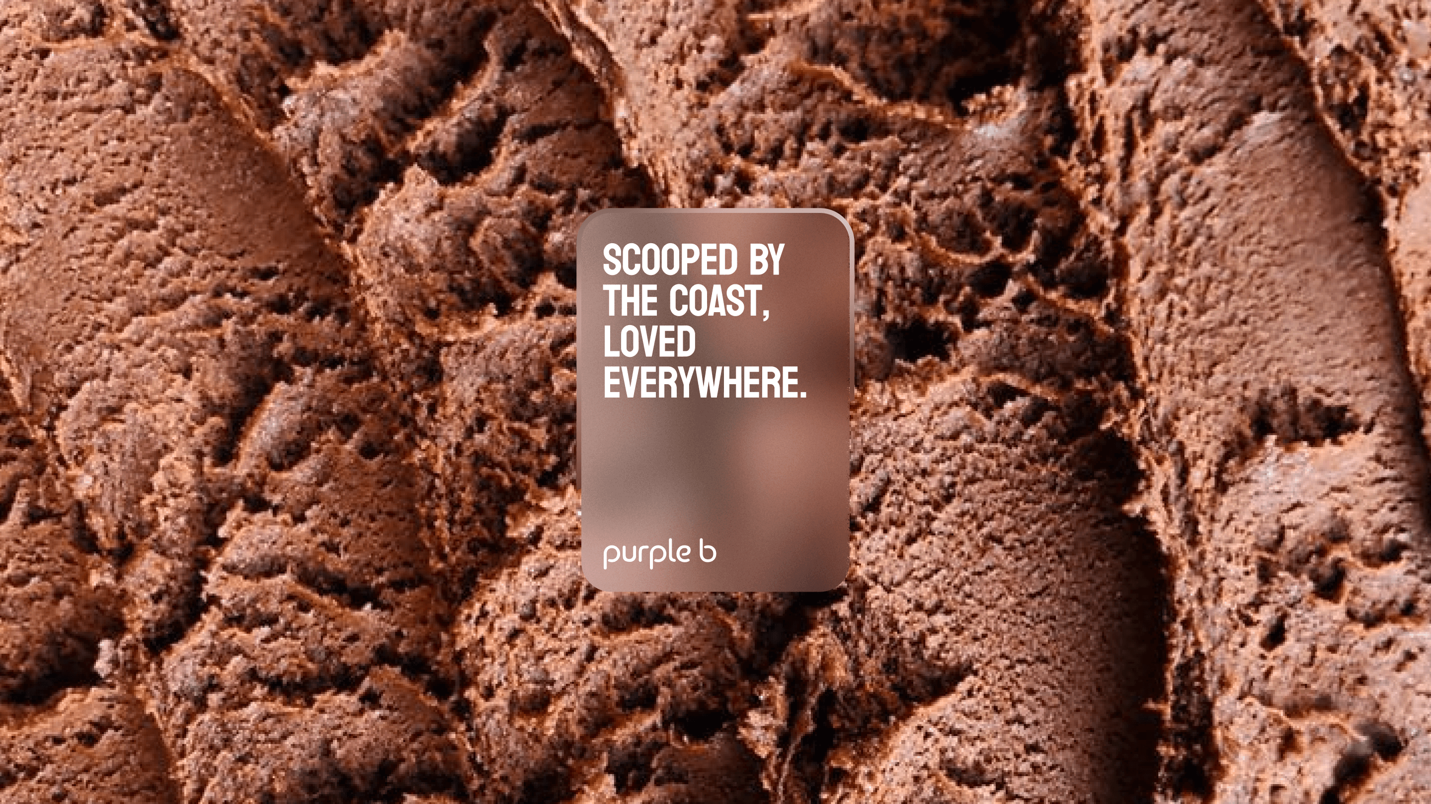 Two women on a couch pulling slices of pizza out of a box