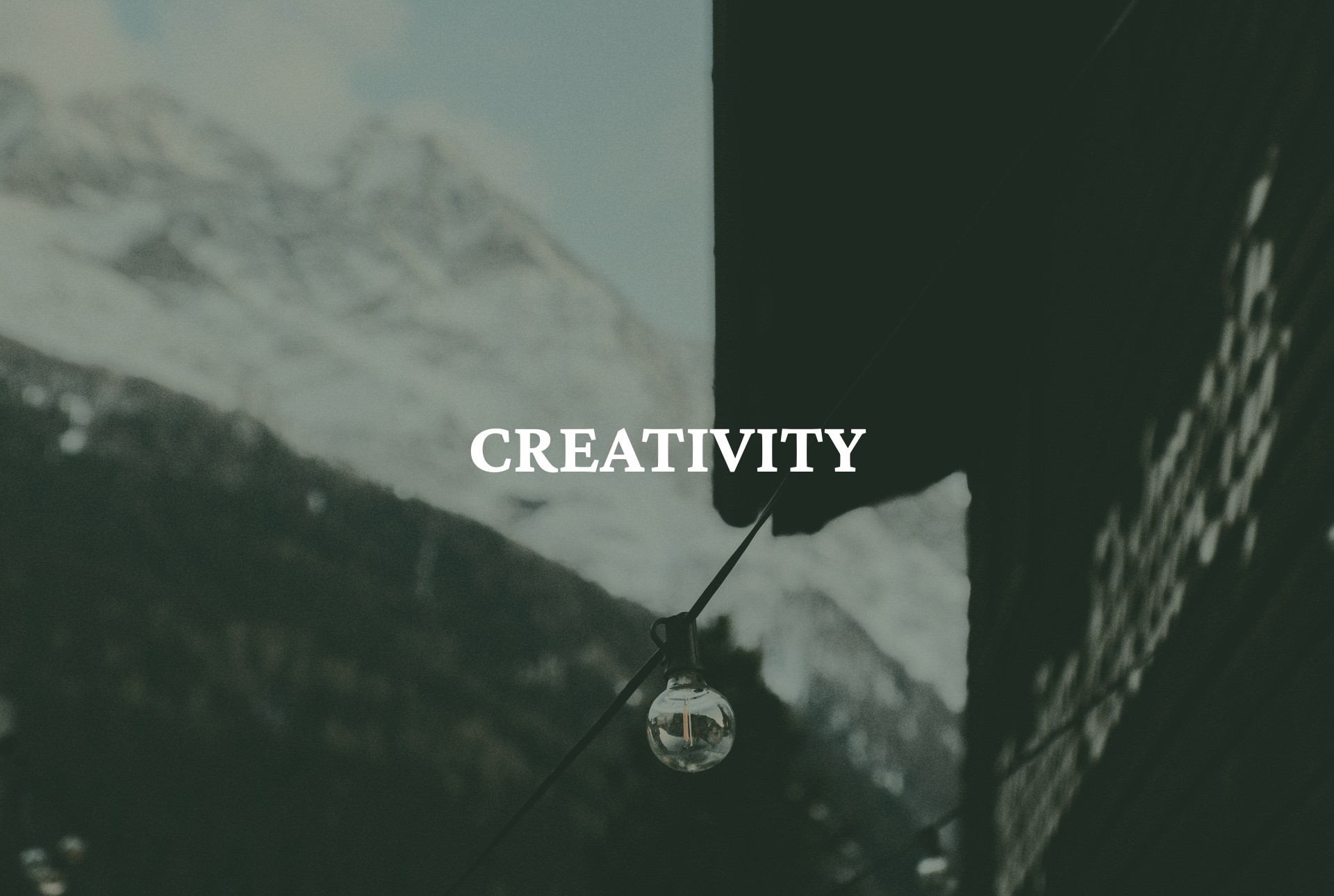 Lightbulb in front of mountain hut representing creativity