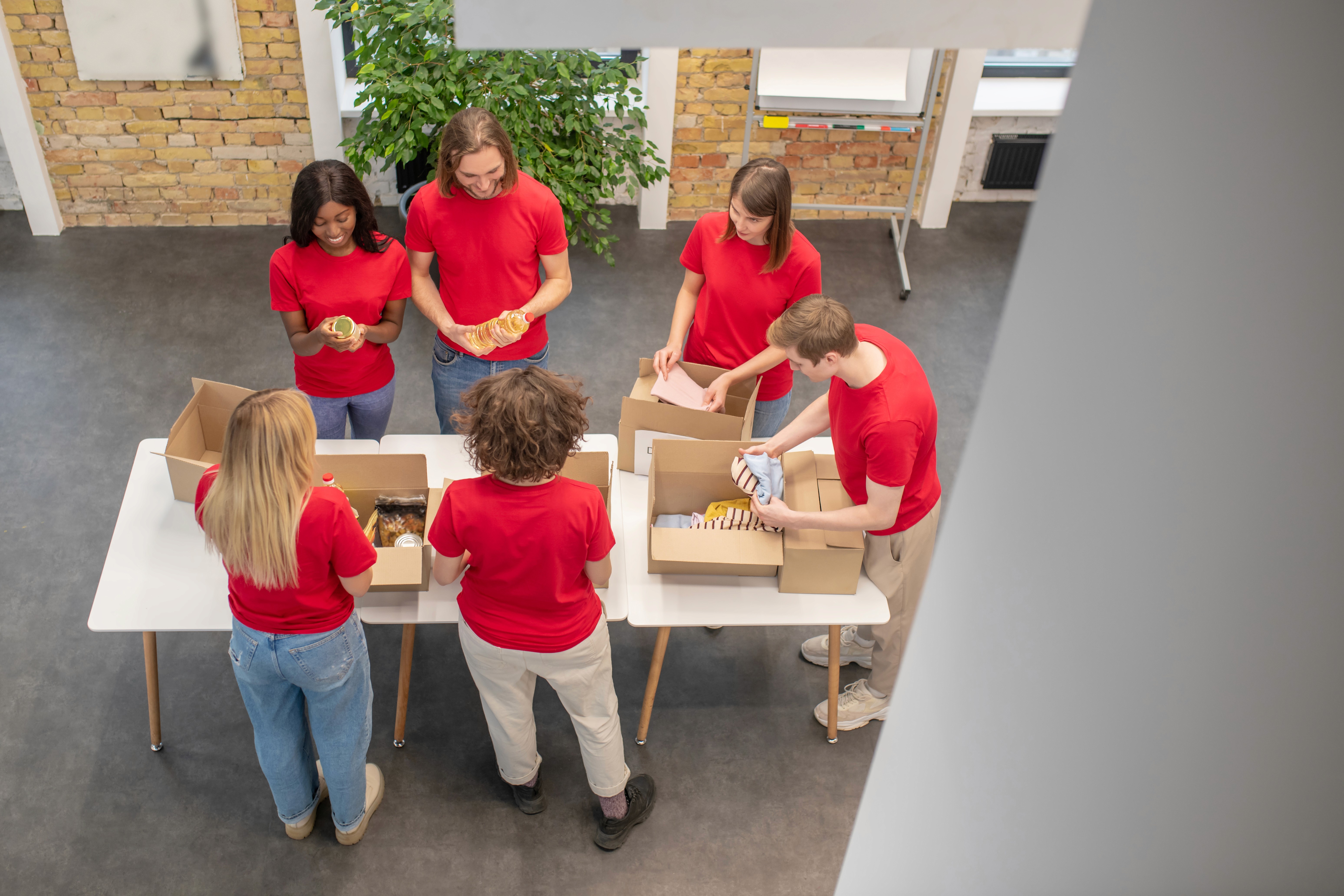 Man & woman stand in front of a few boxes