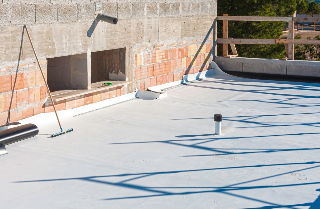 Two roofers at work. Nailing wooden battens on the roof with carpenter hammer or electric nailer