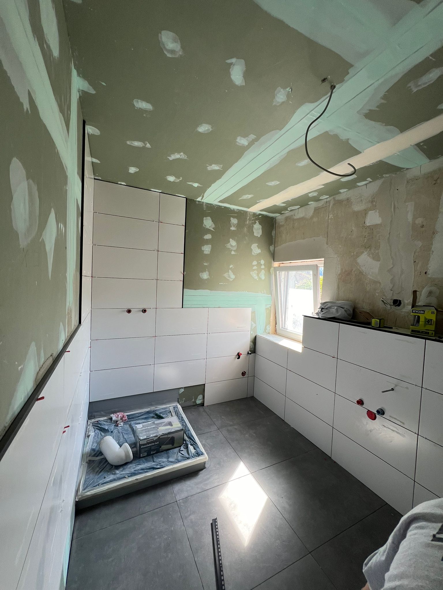 white and gray house near green grass field and trees during daytime