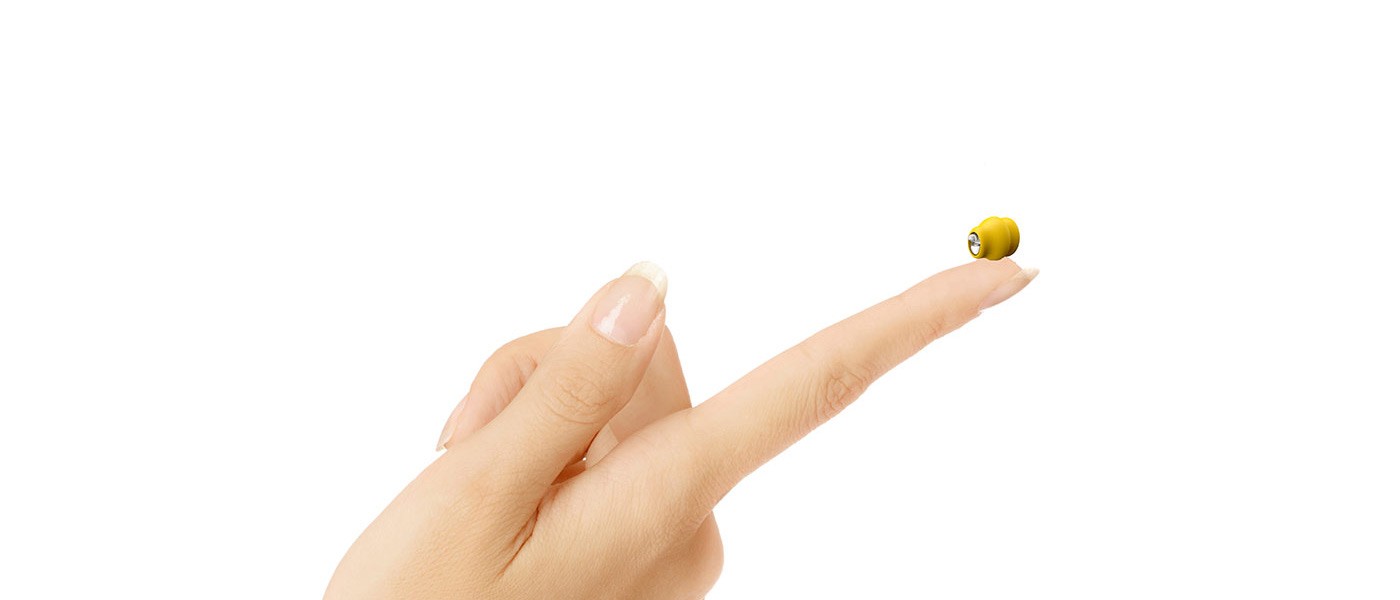 Man sitting in a testing booth having a hearing test