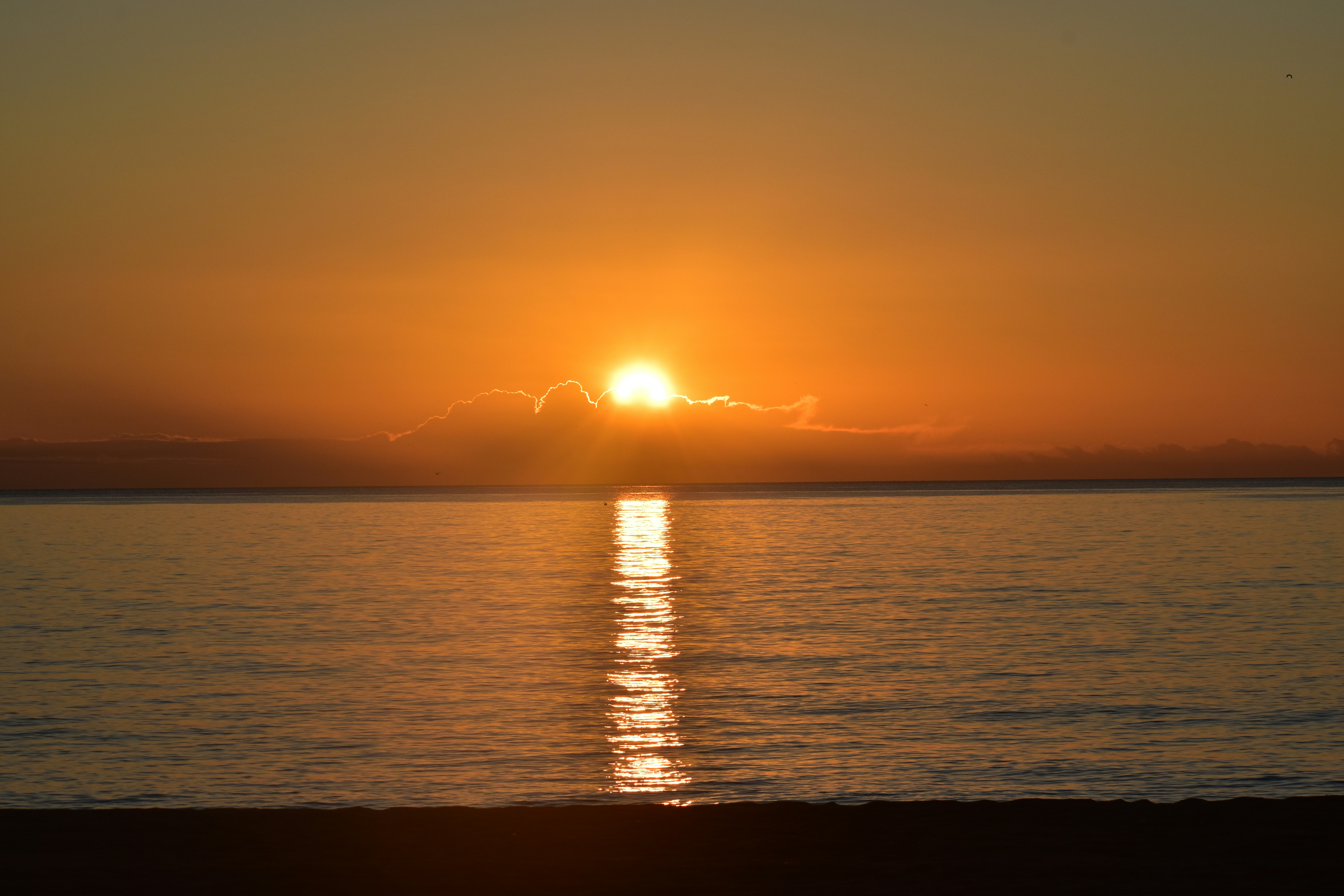 The sun is setting over a body of water