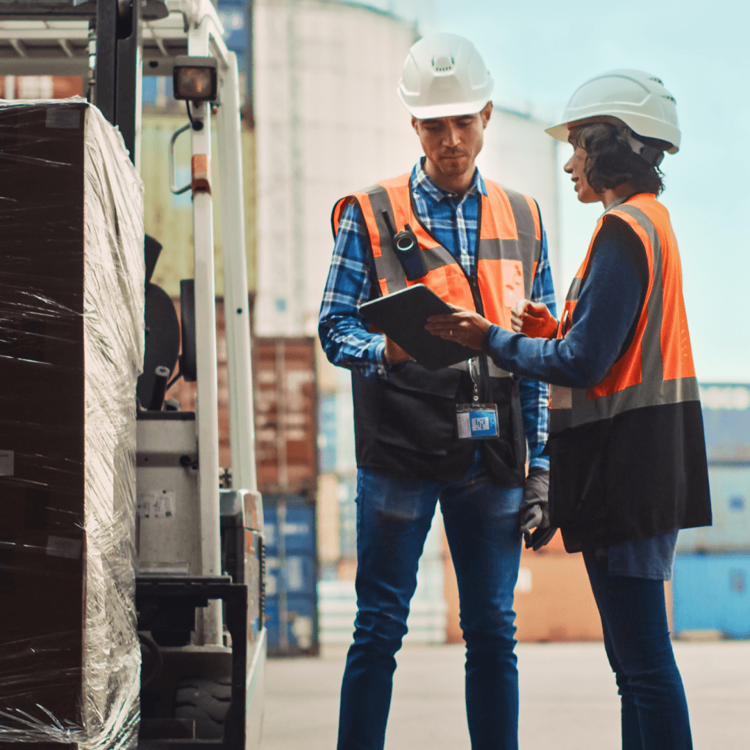3PL staff inspecting wrapped pallets to document load condition with timestamped visual records