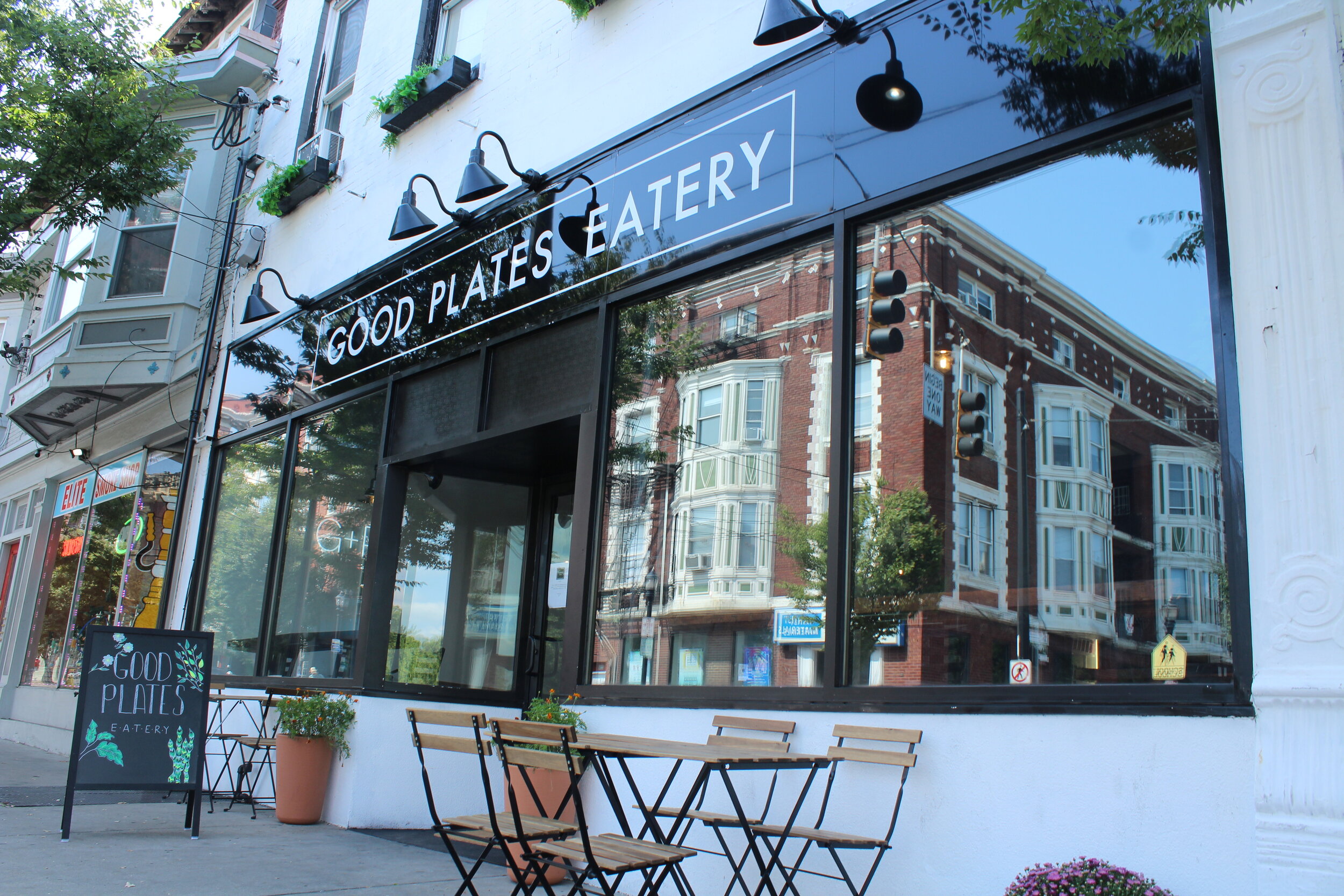 Chef plating a fried chicken sandwich