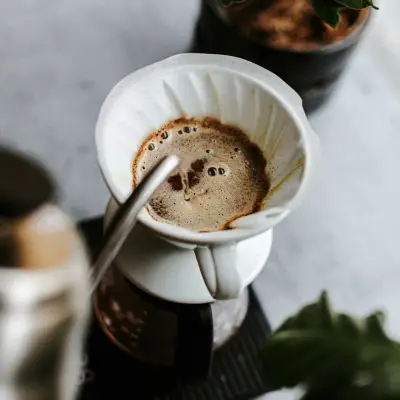 a cup of coffee with a smiley face drawn in it