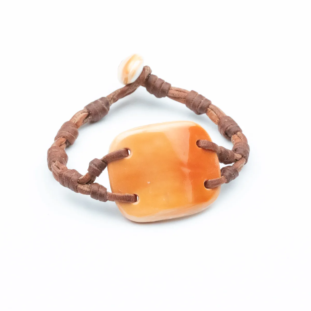 Amber seashell centered on hand-knotted brown leather cord bracelet with shell toggle closure — Manos de Oro Saint Barth