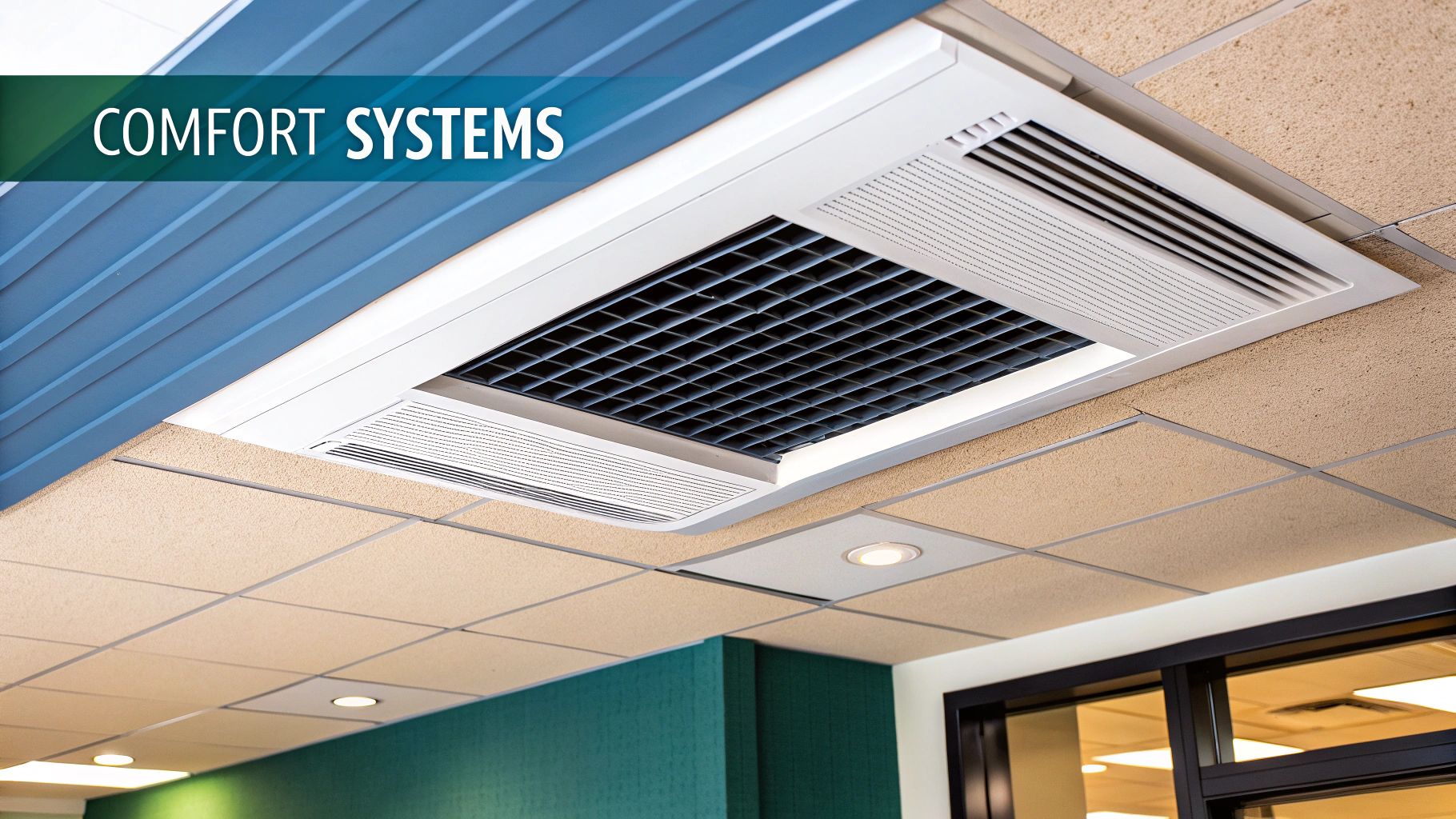 Modern ceiling-mounted HVAC unit and beige acoustic tiles in a commercial space, with 'COMFORT SYSTEMS' banner.